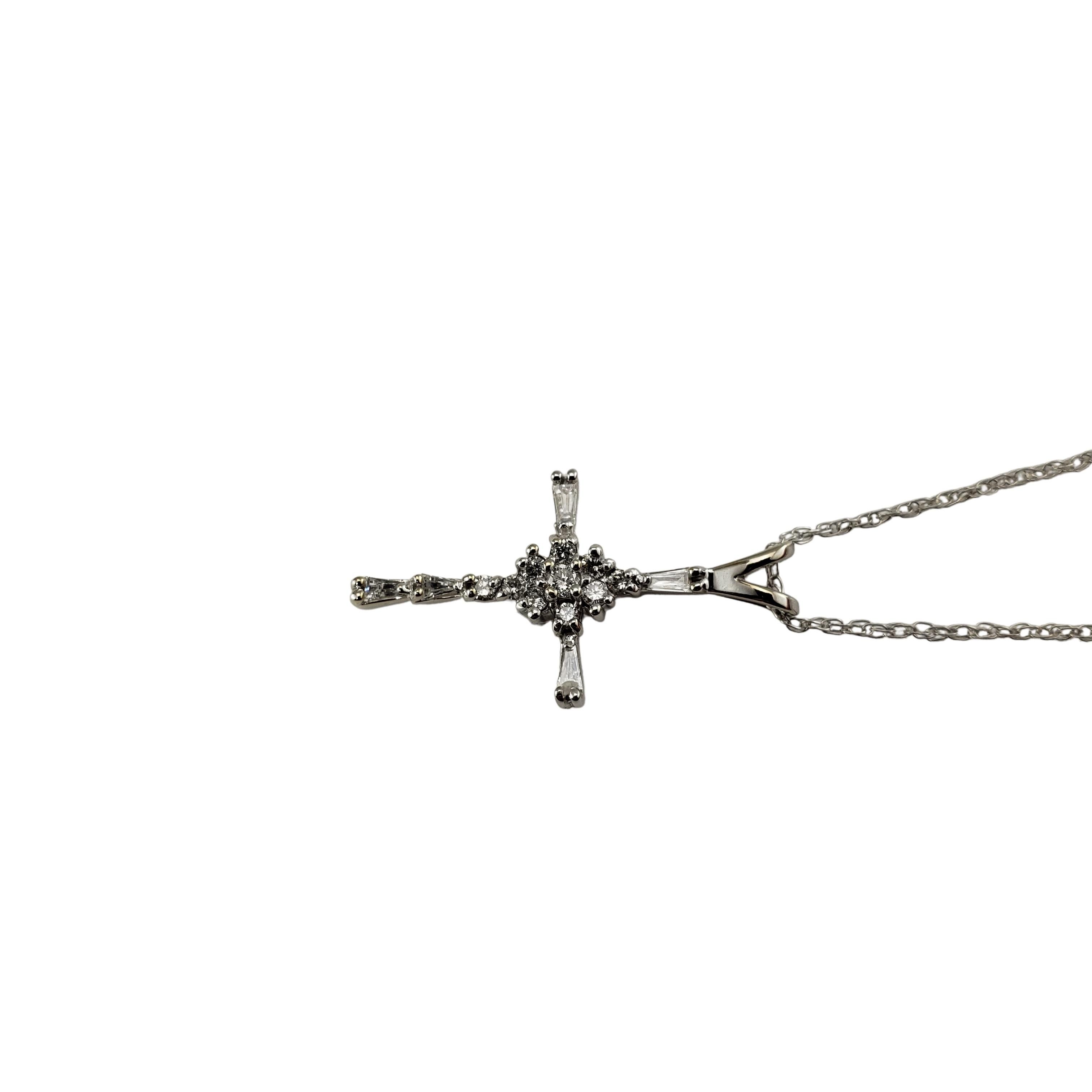 14 Karat White Gold Diamond Cross Pendant Necklace-

This sparkling cross pendant features five baguette diamonds and ten round brilliant cut diamonds.  Suspends from a classic cable chain.  

Approximate total diamond weight:  .40 ct.

Diamond