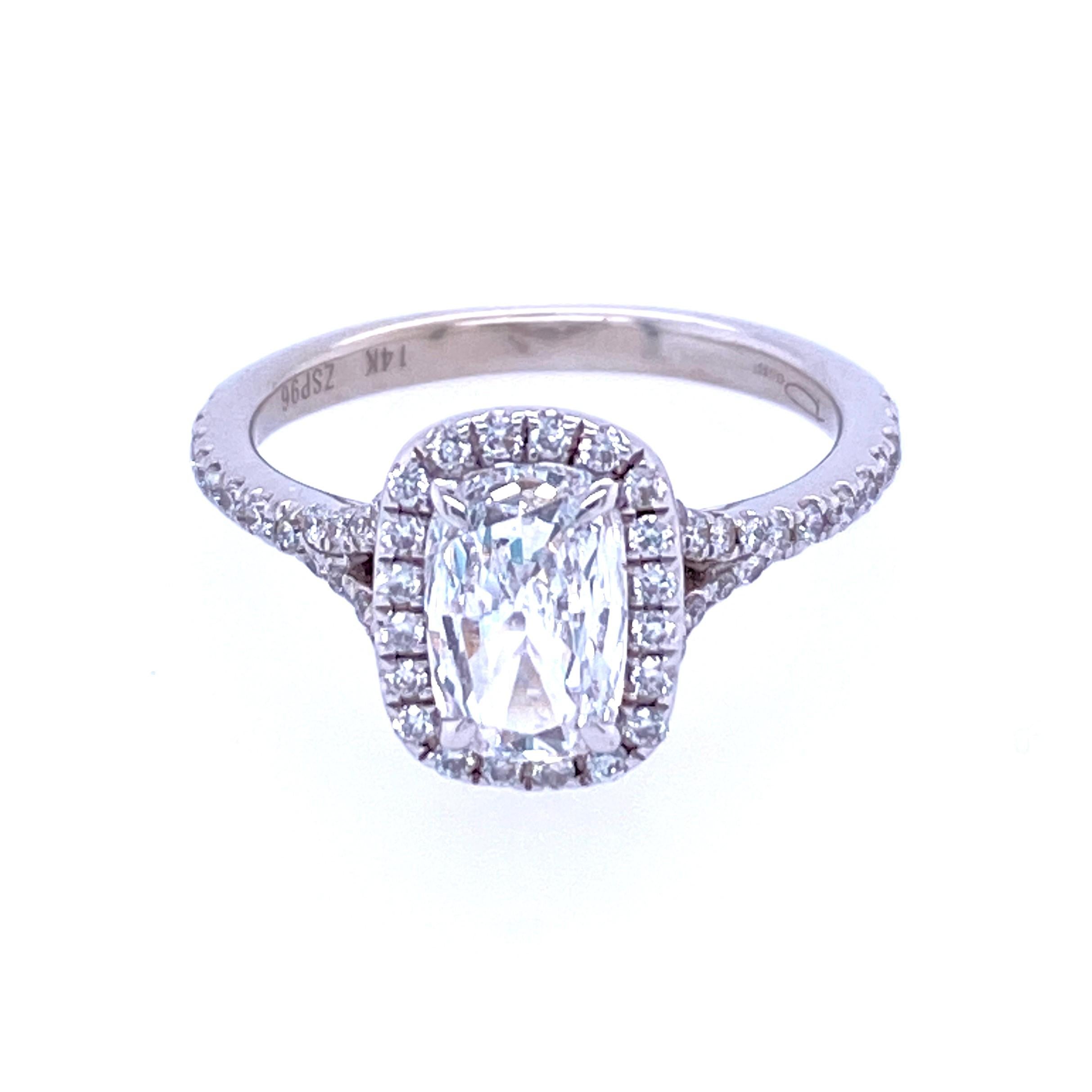 One 14 karat white gold diamond contemporary wedding set featuring one 14 karat white gold (stamped 14K ZSP96) 0.82 carat cushion cut diamond with H color and SI1 clarity set in a halo style setting with 0.28 carat total weight of round brilliant