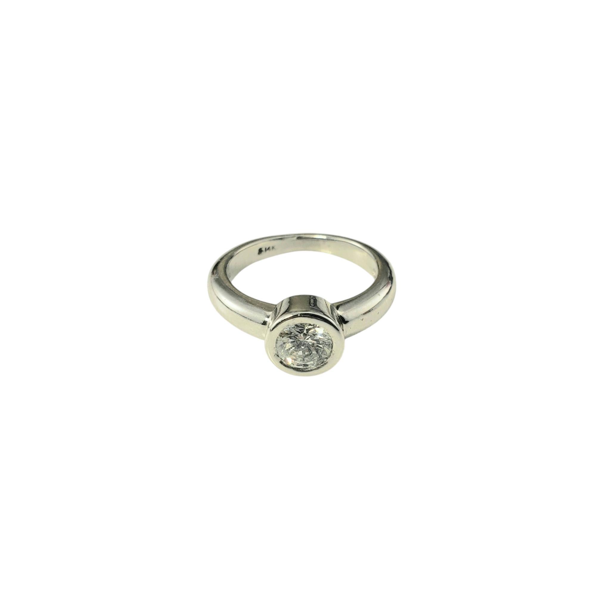 14 Karat White Gold Diamond Engagement Ring Size 5.25 JAGi Certified-

This elegant engagement ring features one round brilliant cut diamond bezel set in classic 14K white gold, providing a modern and sleek way to showcase a sparkling