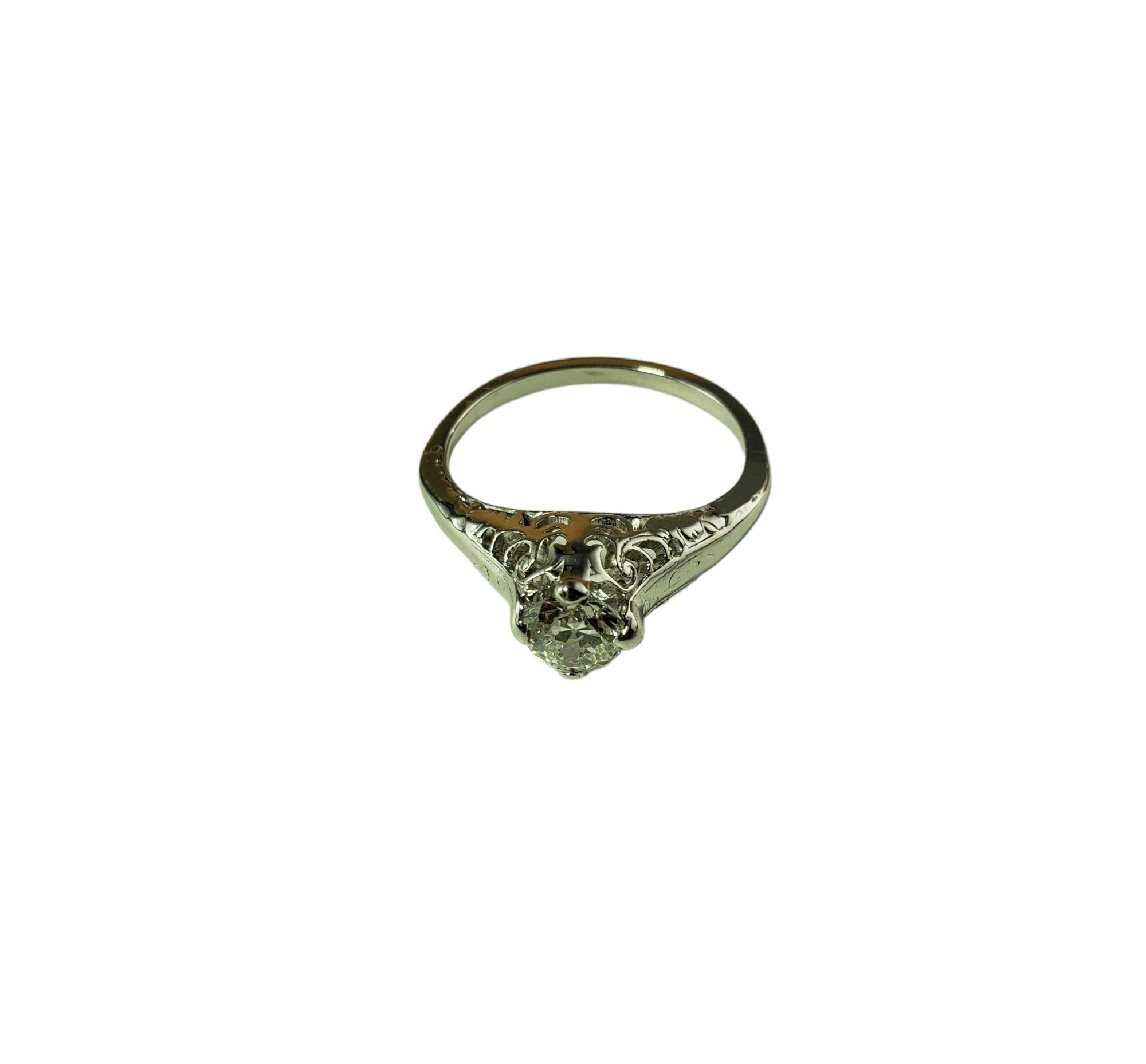 This sparkling ring features one round old mine cut diamond set in beautifully detailed 14K white gold.

Height: 9 mm. Width: 7 mm.

Shank: 2 mm.

Approximate total diamond weight: .50 ct.

Diamond color: J

Diamond clarity: SI2

Size: 7

Weight: 