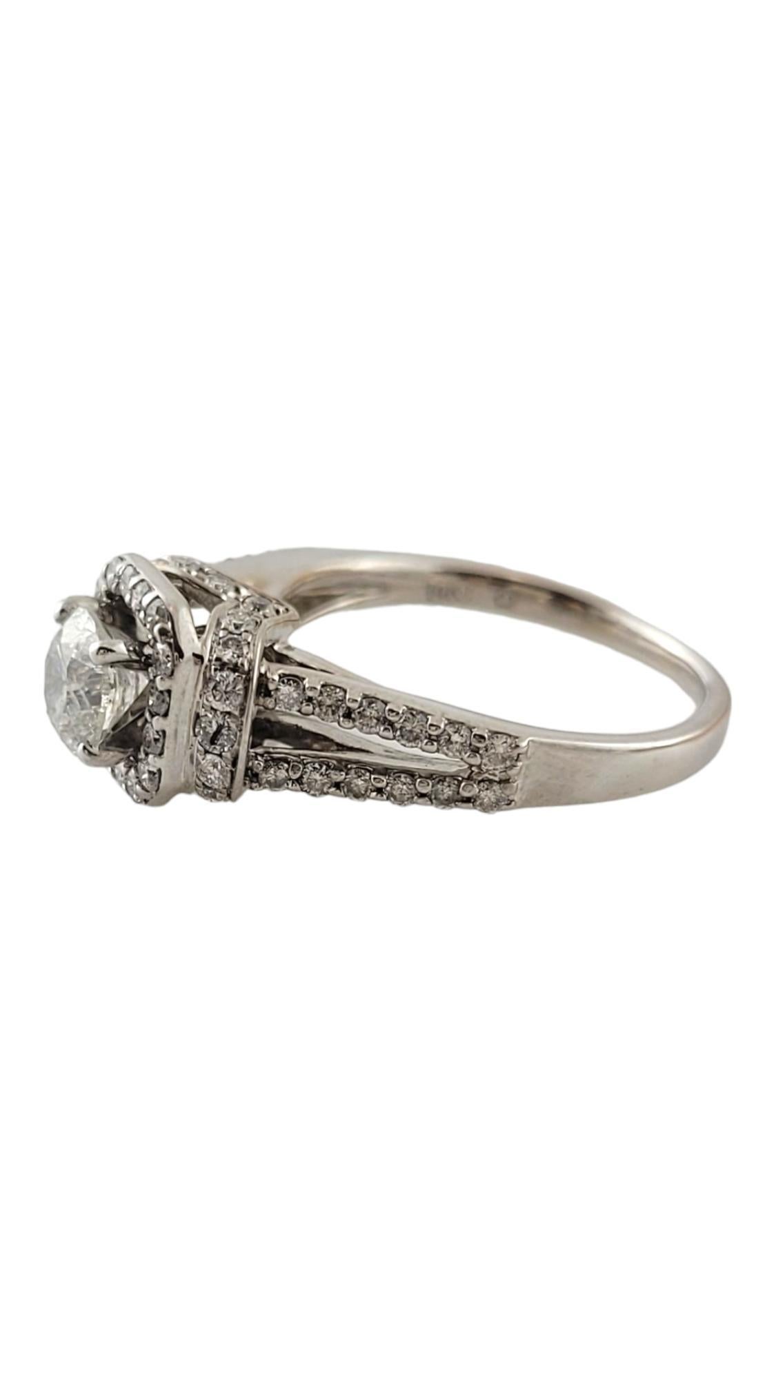This sparkling ring features one round brilliant cut diamond (.70 ct.) surrounded by 60 round brilliant cut diamonds on the halo and band.  Shank:  1.5 mm.

Approximate total diamond weight:  1.12 ct.

Diamond color: G-H

Diamond clarity: