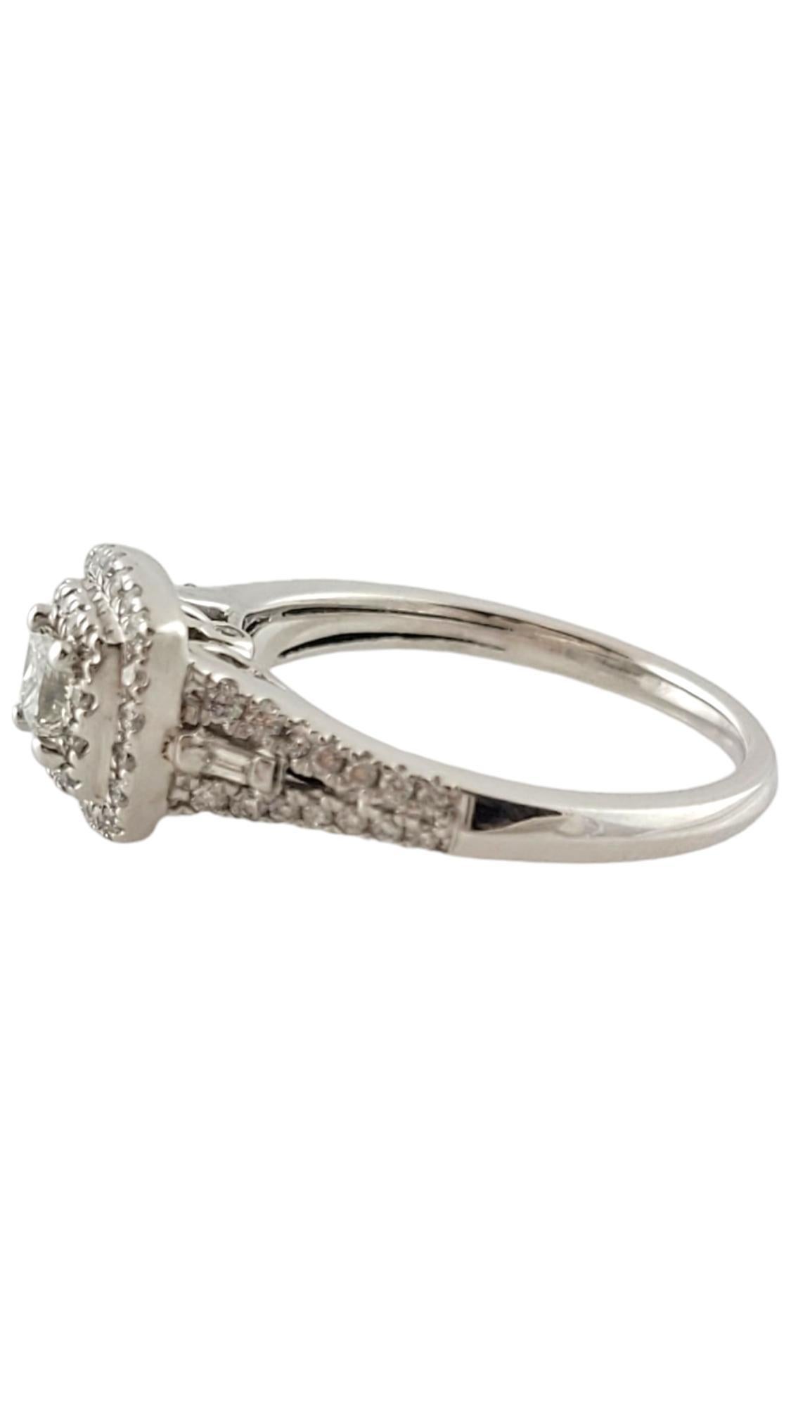 14 Karat White Gold and Diamond Engagement Ring JAGi Certified-

This sparkling ring features one princess cut diamond (.38 ct.) accented with two baguette diamonds and 62 round brilliant cut diamonds set in beautifully detailed 14K white gold. 