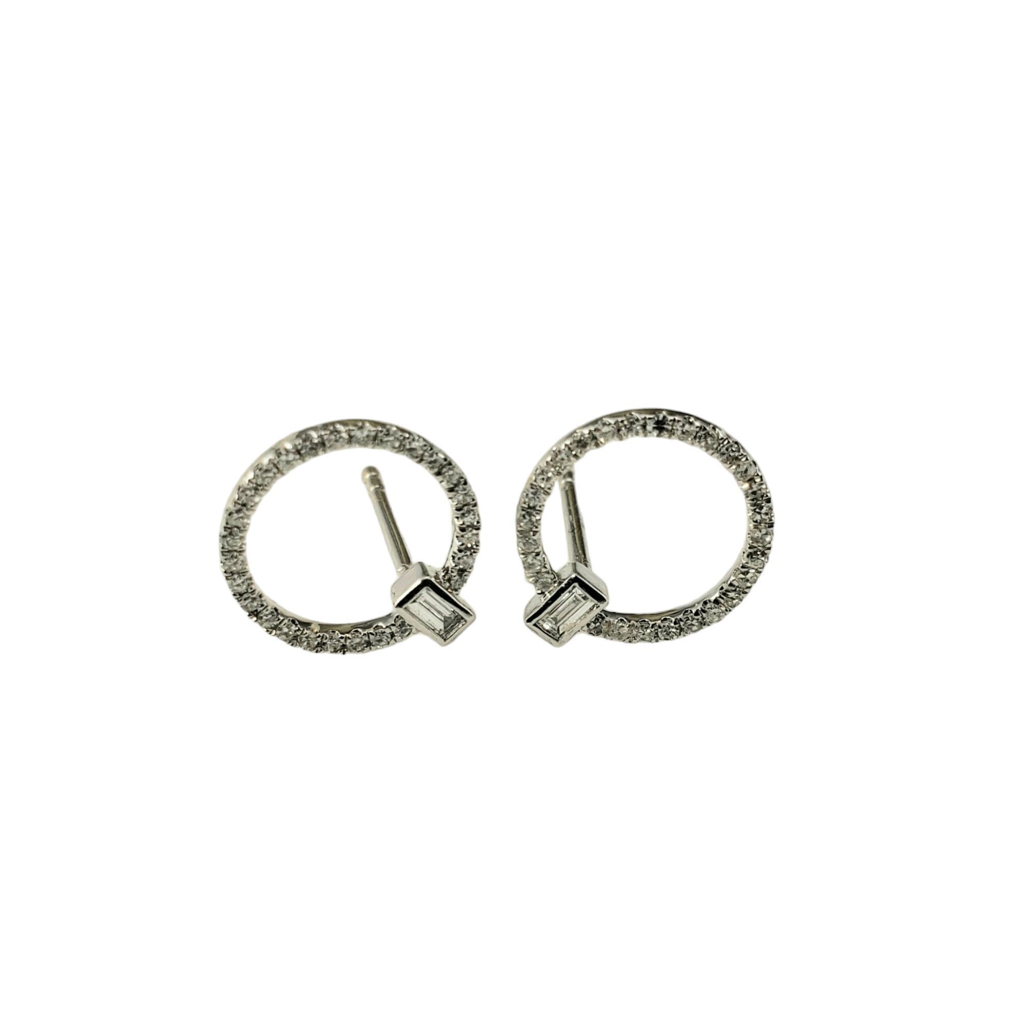14 Karat White Gold Diamond Eternity Circle Earrings-

These sparkling circle earrings each feature one emerald cut diamond (.10 ct.) and round single cut diamonds set in 14K white gold.  Push back closures.

Approximate total diamond weight: .30