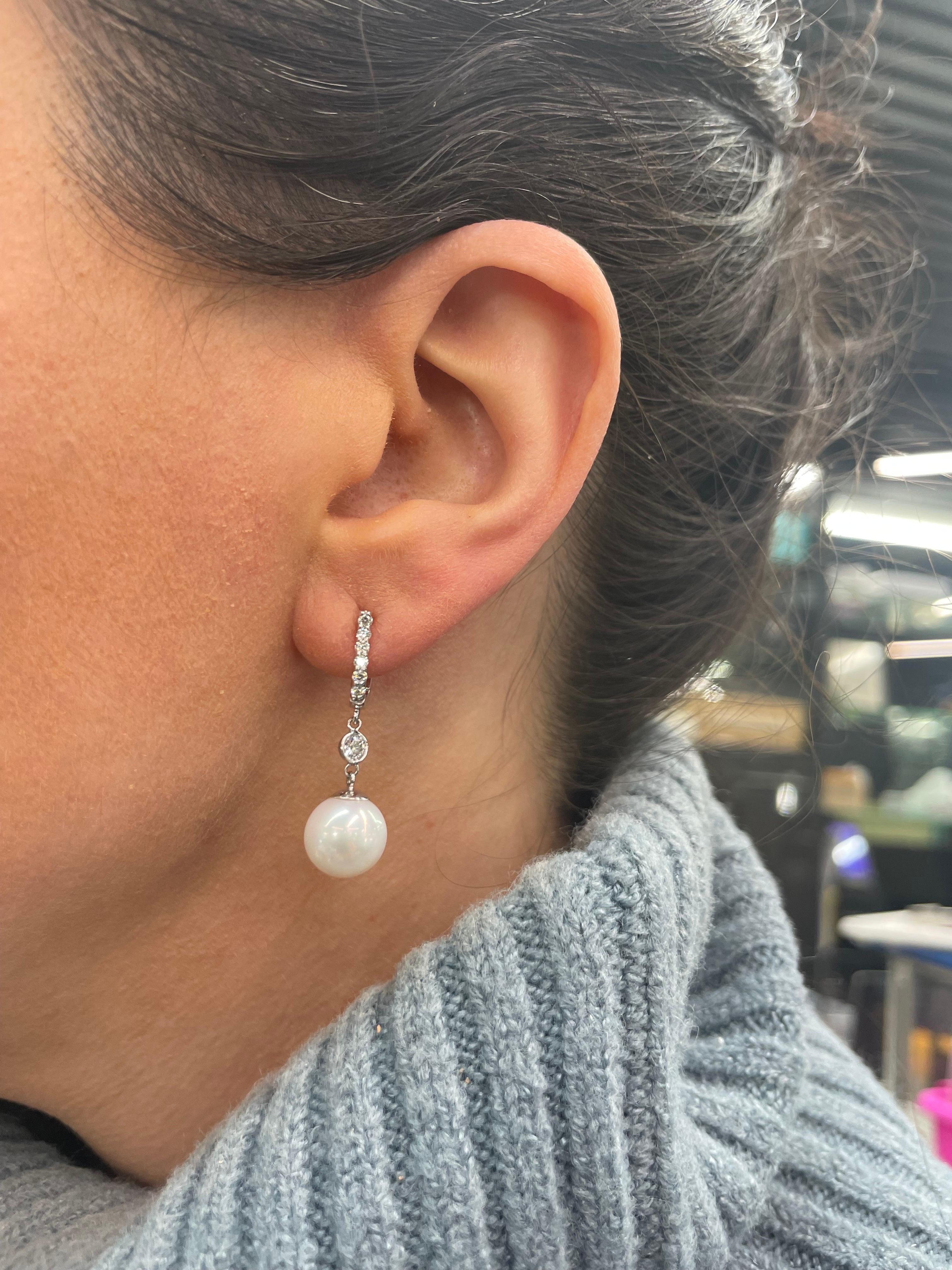 14 Karat White Gold drop earrings featuring two Freshwater pearls measuring 10-10.5 mm with 14 round brilliants in the diamond hoop weighing 0.48 carats and two round brilliants weighing 0.22 carats.

Can customize in pearl color and gold color. 
