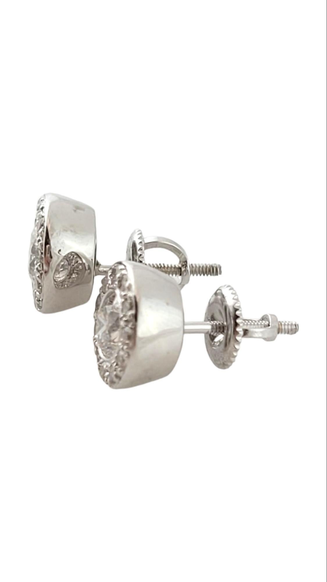 14 Karat White Gold Diamond Halo Earring JAGi Certified-

These sparkling stud halo earrings each feature 13 round brilliant cut diamonds (center: .53 ct.) set in classic 14K white gold. Screw back closures.

Total diamond weight:  1.39 ct.

Diamond