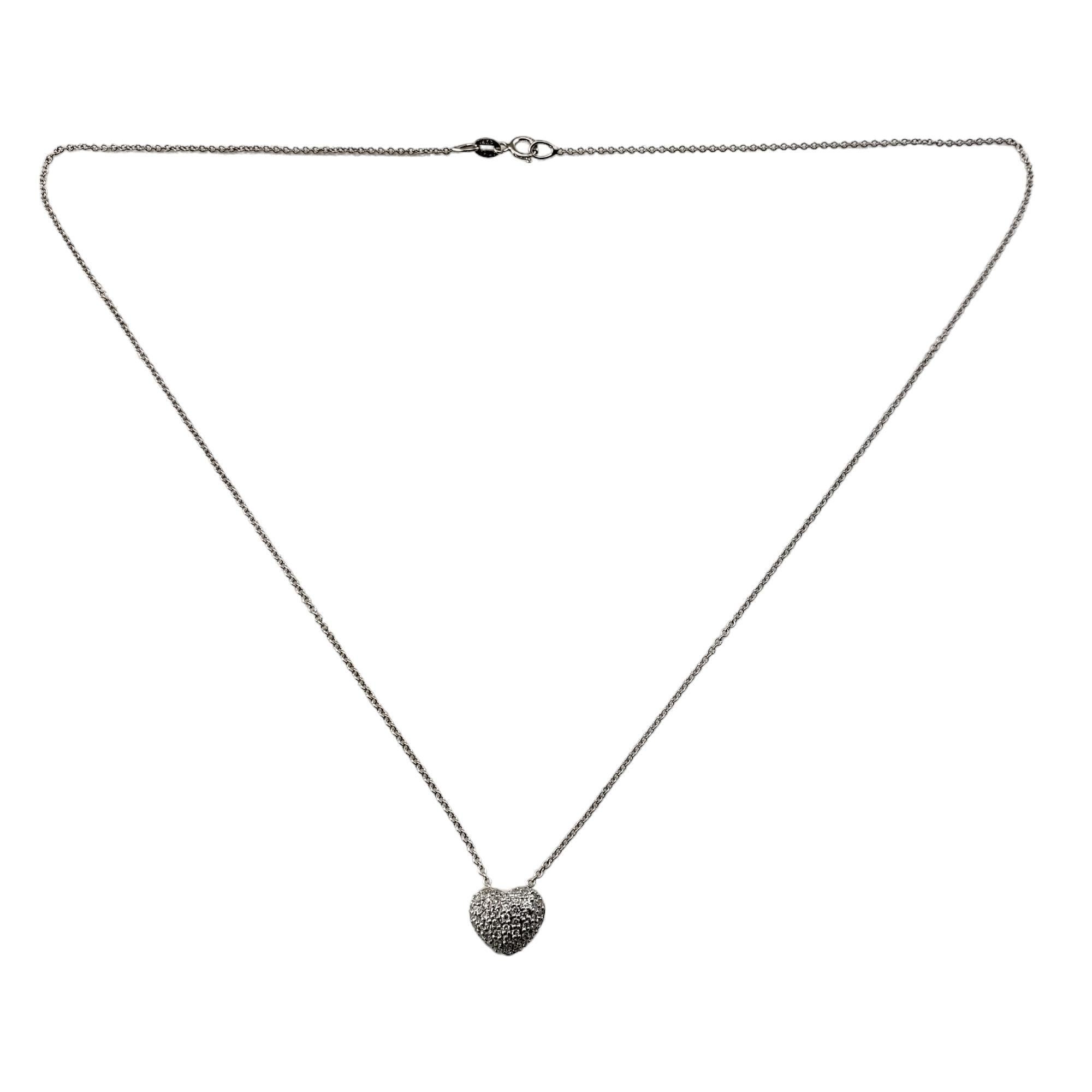 Vintage 14 Karat White Gold Diamond Heart Pendant Necklace-

This sparkling heart pendant features 55 round single cut diamonds set in classic 14K white gold.  Suspends from a classic cable necklace. 

Approximate total diamond weight:  .25
