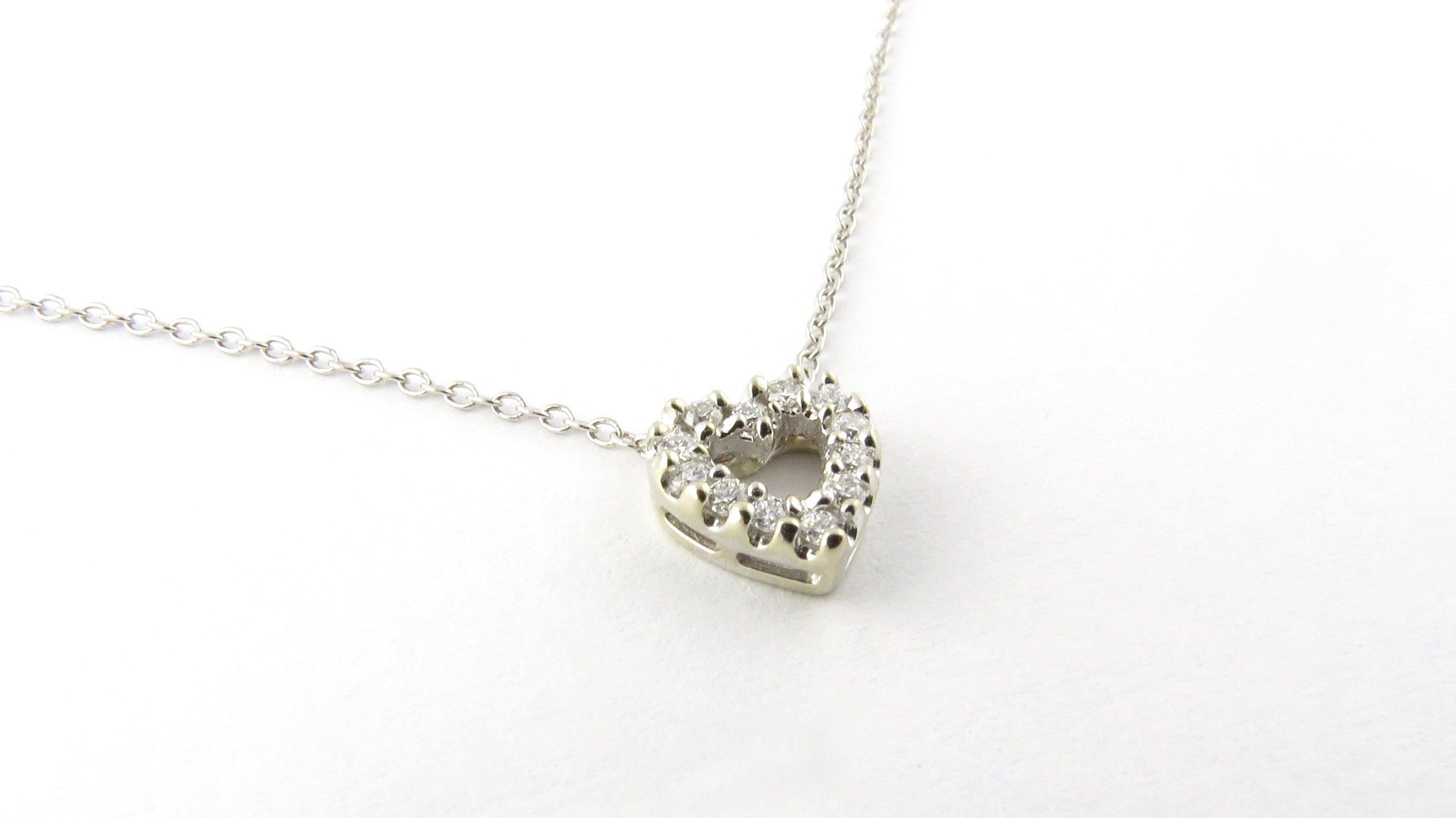 Vintage 14 Karat White Gold Diamond Heart Pendant Necklace- 
This sparkling heart slide pendant (8 mm x 8 mm) is decorated with 12 round brilliant cut diamonds suspended from a 15