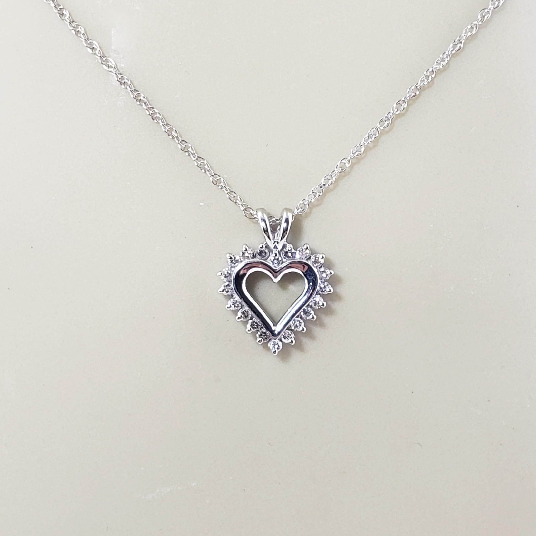 Vintage 14 Karat White Gold Diamond Heart Pendant Necklace-

This sparkling heart pendant features 20 round brilliant cut diamonds set in elegant 14K white gold. Suspends from a classic cable chain.

Approximate total diamond weight: .20