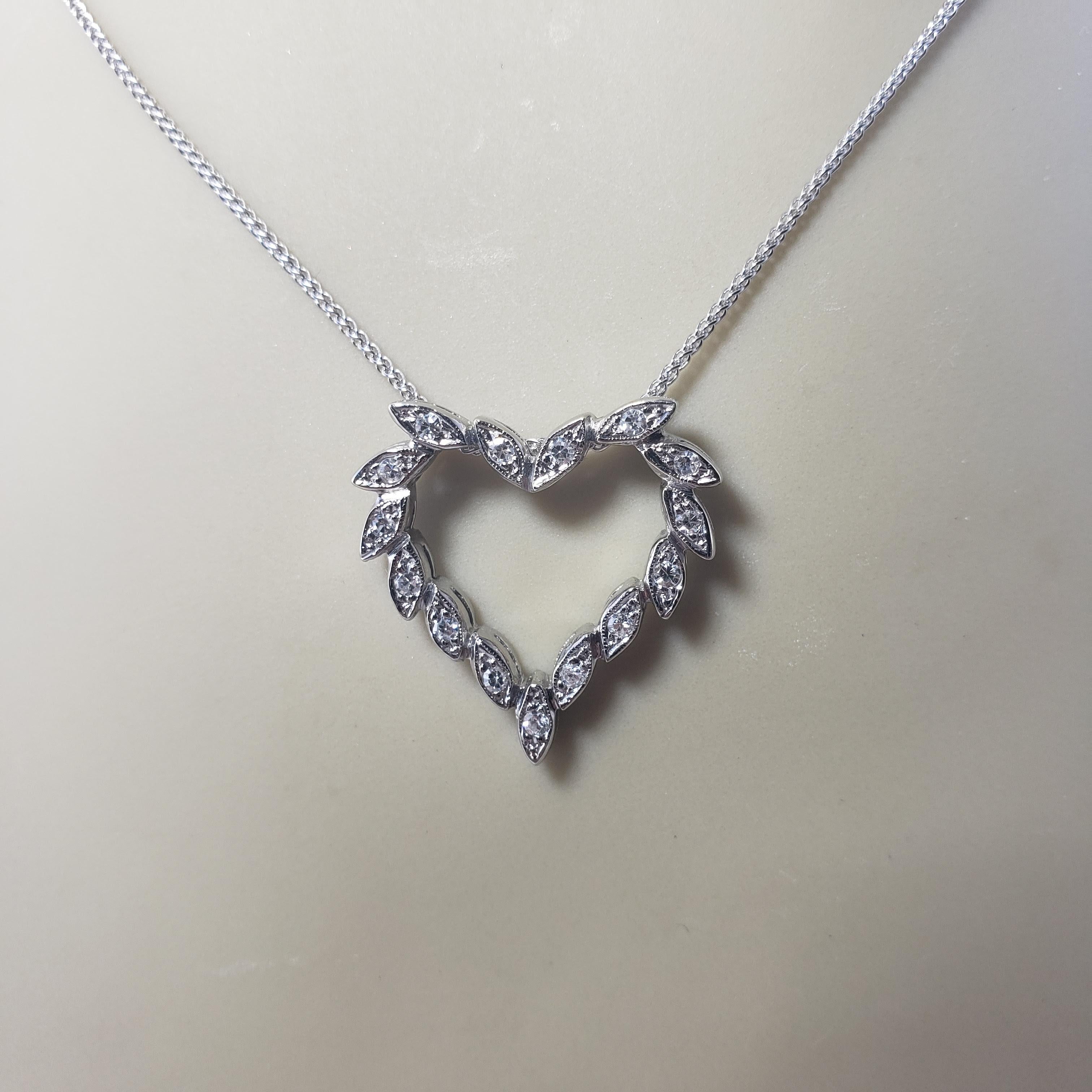 Vintage 14 Karat White Gold Diamond Heart Pendant Necklace-

This sparkling heart pendant features 15 round single cut diamonds set in classic 14K white gold. Suspends from a classic cable necklace.

Approximate total diamond weight: .15