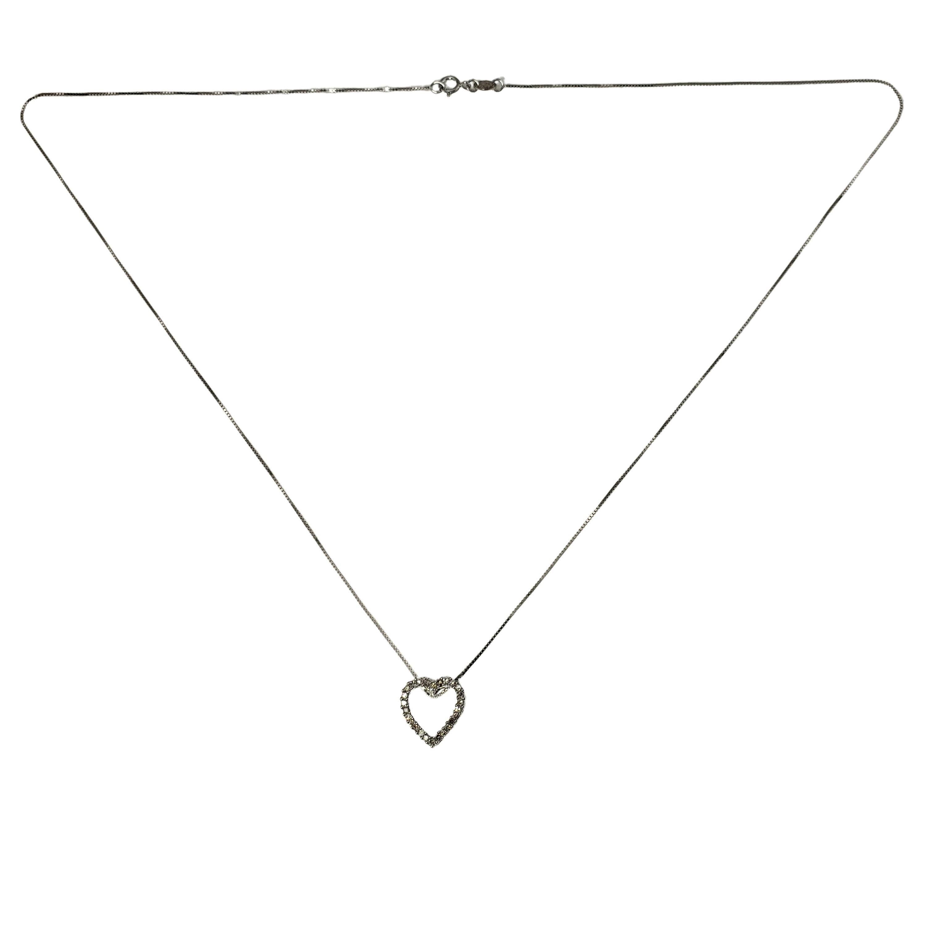 Vintage 14 Karat White Gold Diamond Heart Pendant Necklace-

This sparkling heart pendant features 26 round brilliant cut diamonds set in 14K white gold. Suspends from a classic box chain.

Approximate total diamond weight: .13 ct.

Diamond clarity: