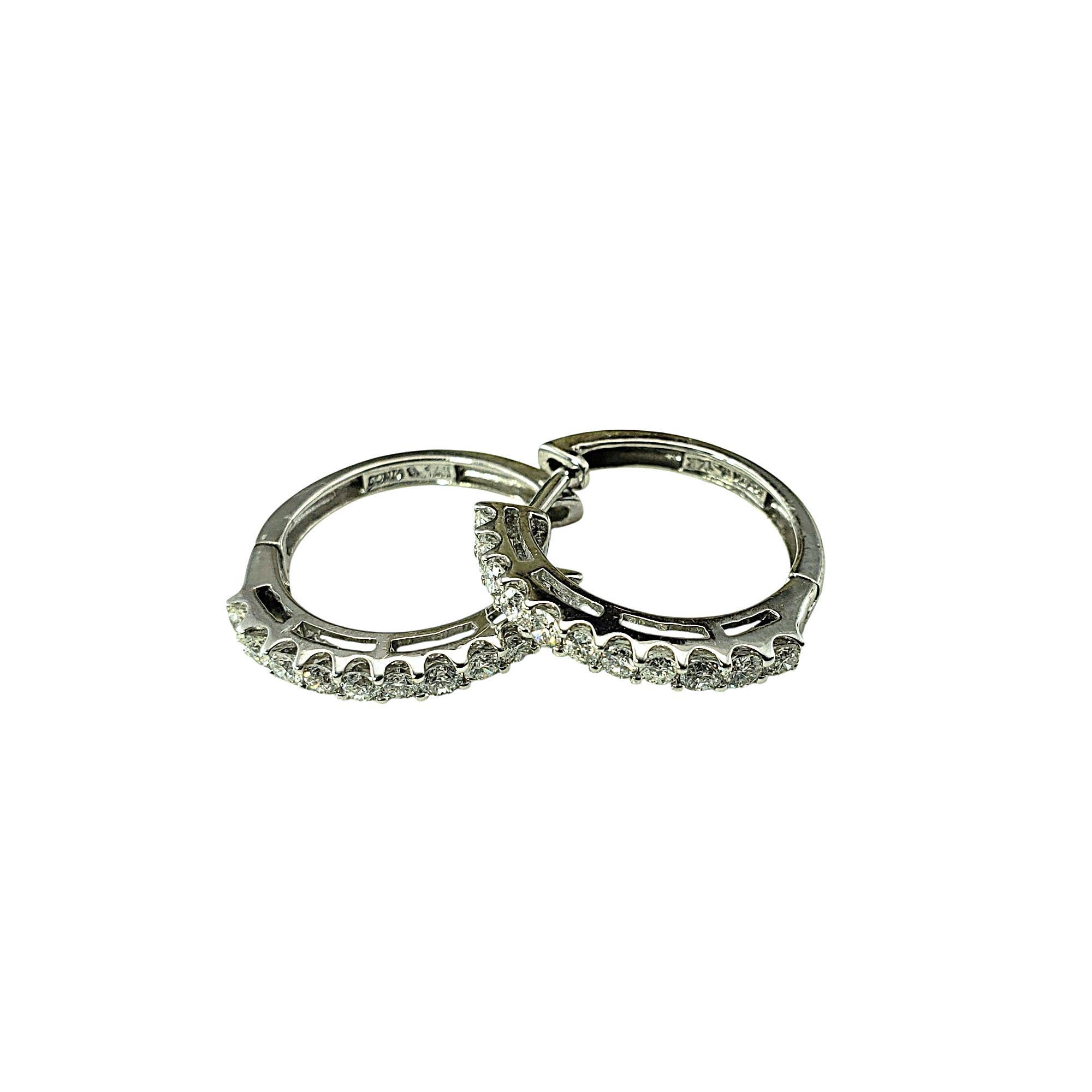 14 Karat White Gold Diamond Hoop Earrings-

Timeless elegance meets everyday luxury with these 14K white gold hoop earrings, each set with 11 round brilliant cut diamonds. These dazzling hoops offer just the right size and sparkle for day-to-night