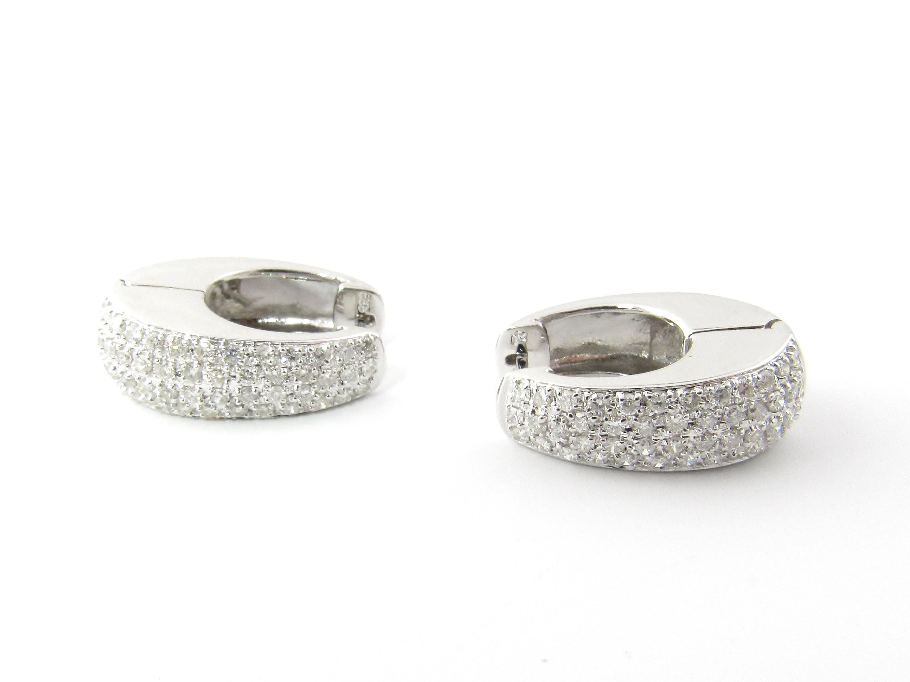 14 Karat White Gold Diamond Hoop Earrings-

These dazzling hinged hoop earrings each feature 47 round brilliant cut diamonds set in classic 14K white gold.

Approximate total diamond weight:  .94 ct.

Diamond color:  I

Diamond clarity: 