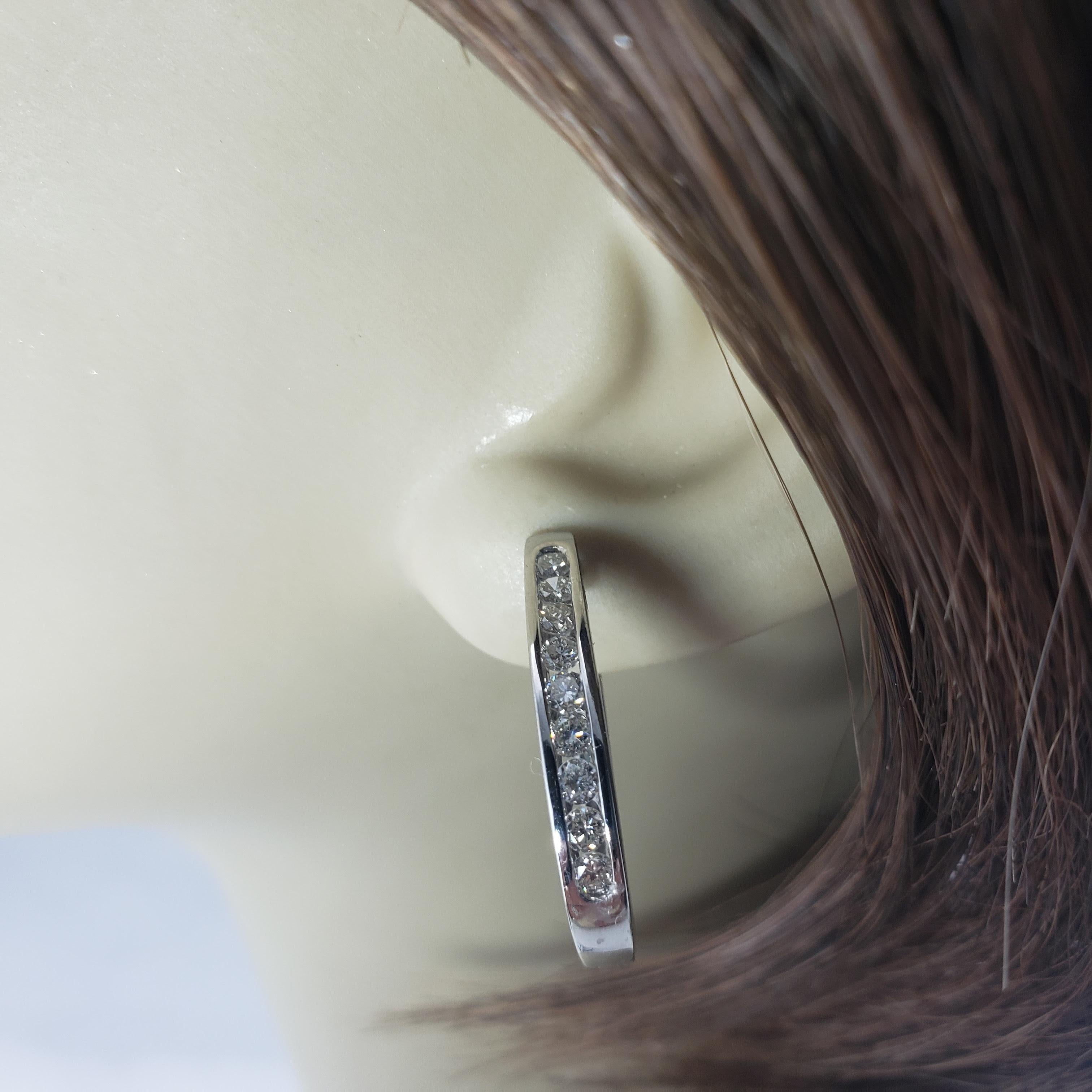 Vintage 14 Karat White Gold Diamond Hoop Earrings-

These sparkling hinged hoop earrings each feature nine round brilliant cut diamonds set in classic 14K white gold.

Approximate total diamond weight: .72 ct.

Diamond color: I-K

Diamond clarity: