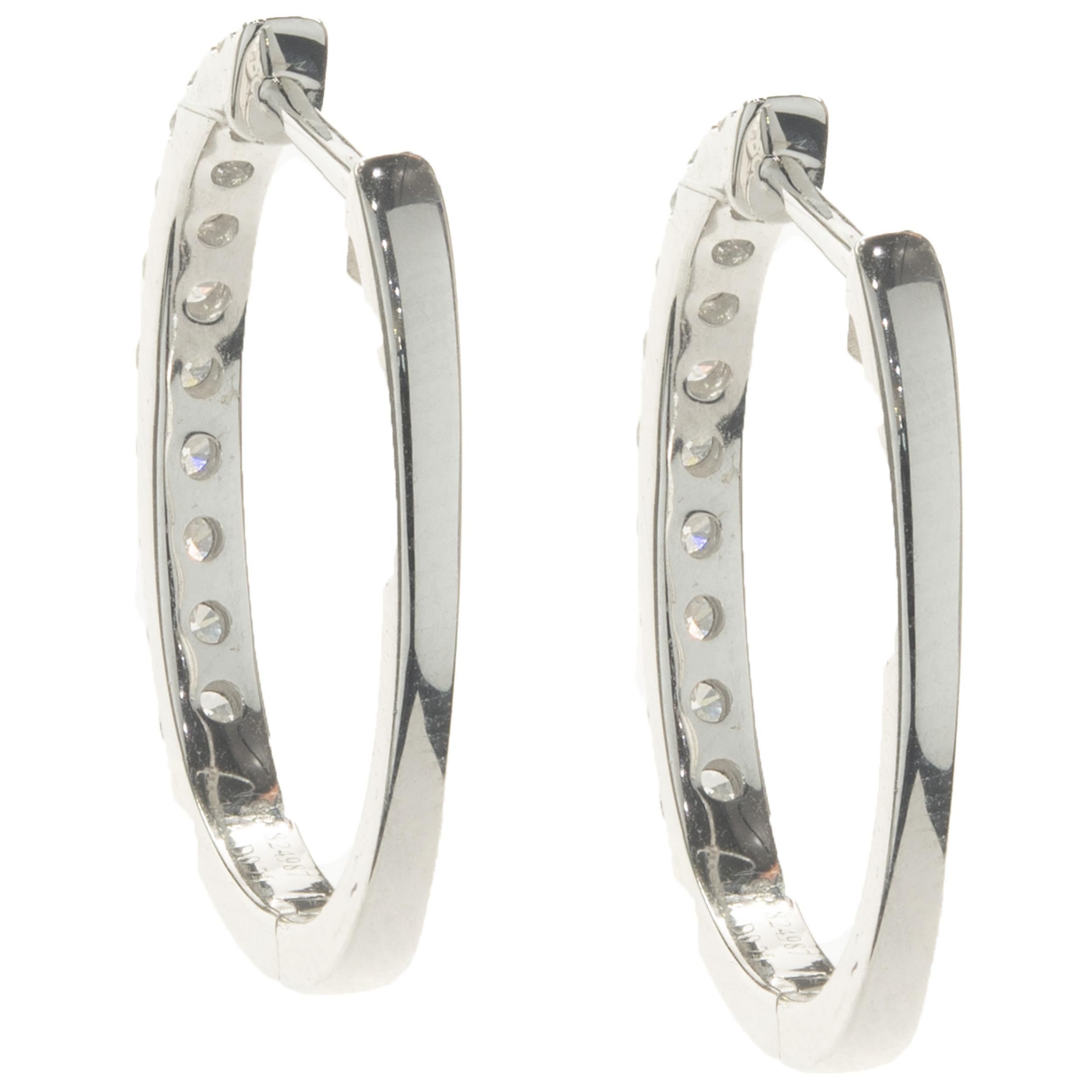 Designer: custom design
Material: 14K white gold
Diamonds: 20 round brilliant cut = 0.73cttw
Color: G
Clarity: SI1
Dimensions: earrings measure 22mm long
Weight: 4.07 grams