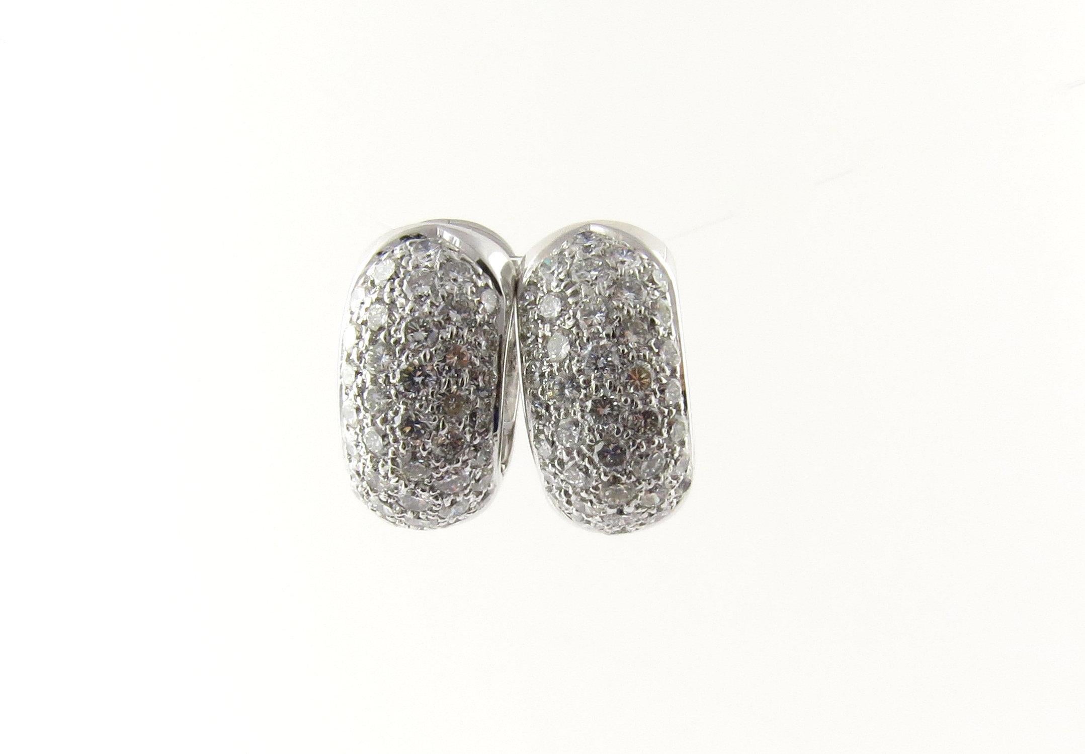 Vintage 14 Karat White Gold Diamond Huggie Earrings- 
This sparkling huggie earrings each feature 40 round brilliant cut diamonds set in classic 14K white gold. 
Approximate total diamond weight: 2 cts. 
Diamond color: G 
Diamond clarity: VS2 
Size: