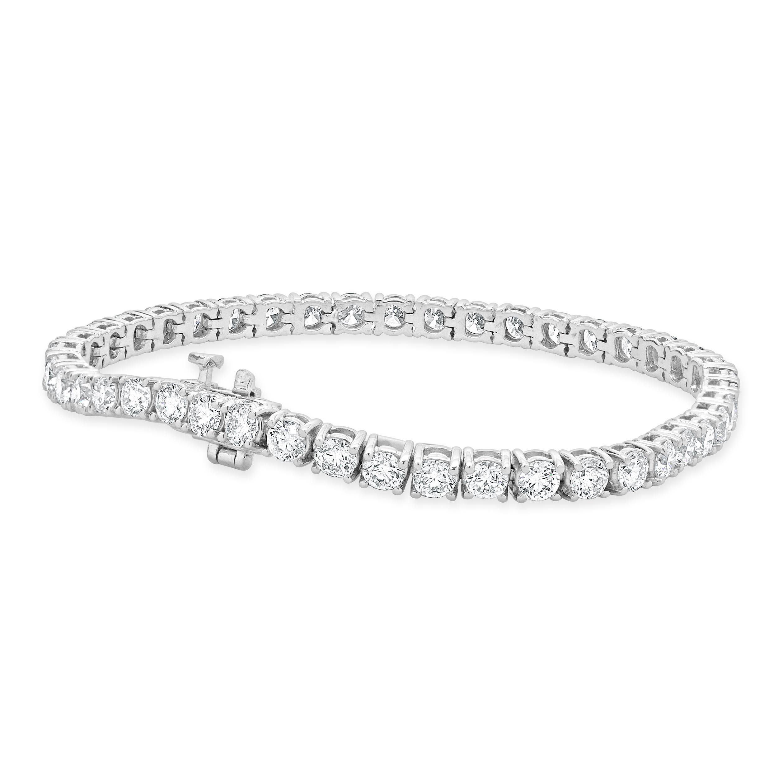 Designer: custom design
Material: 14K white gold
Diamond: round brilliant cut = 8.00cttw
Color: G / H
Clarity: SI1
Dimensions: bracelet will fit up to a 7-inch wrist
Weight: 12.28 grams
