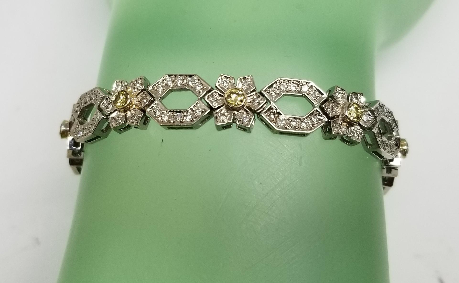 14 karat white gold diamond link bracelet with natural yellow diamonds, containing 176 round full cut white diamonds of very fine quality weighing 1.75cts. and 11 round full cut natural yellow diamonds of very fine quality weighing .90pts.  bracelet
