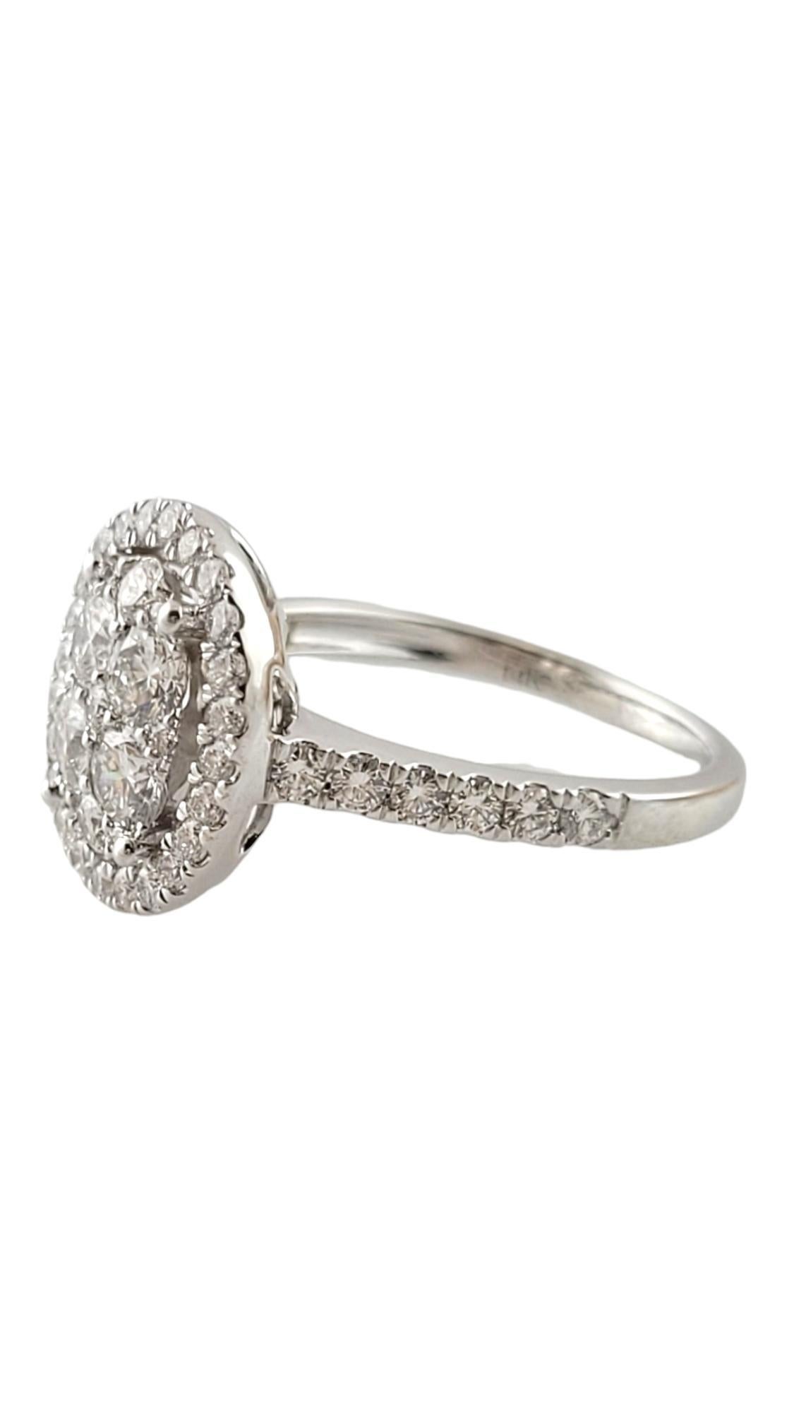This sparkling cluster ring is decorated with round brilliant cut diamonds set in beautifully detailed 14K white gold.  

Top of ring measures 14 mm x 12 mm.  Shank:  2 mm.

Approximate total diamond weight:  1.41 ct.

Diamond color: E-F

Diamond