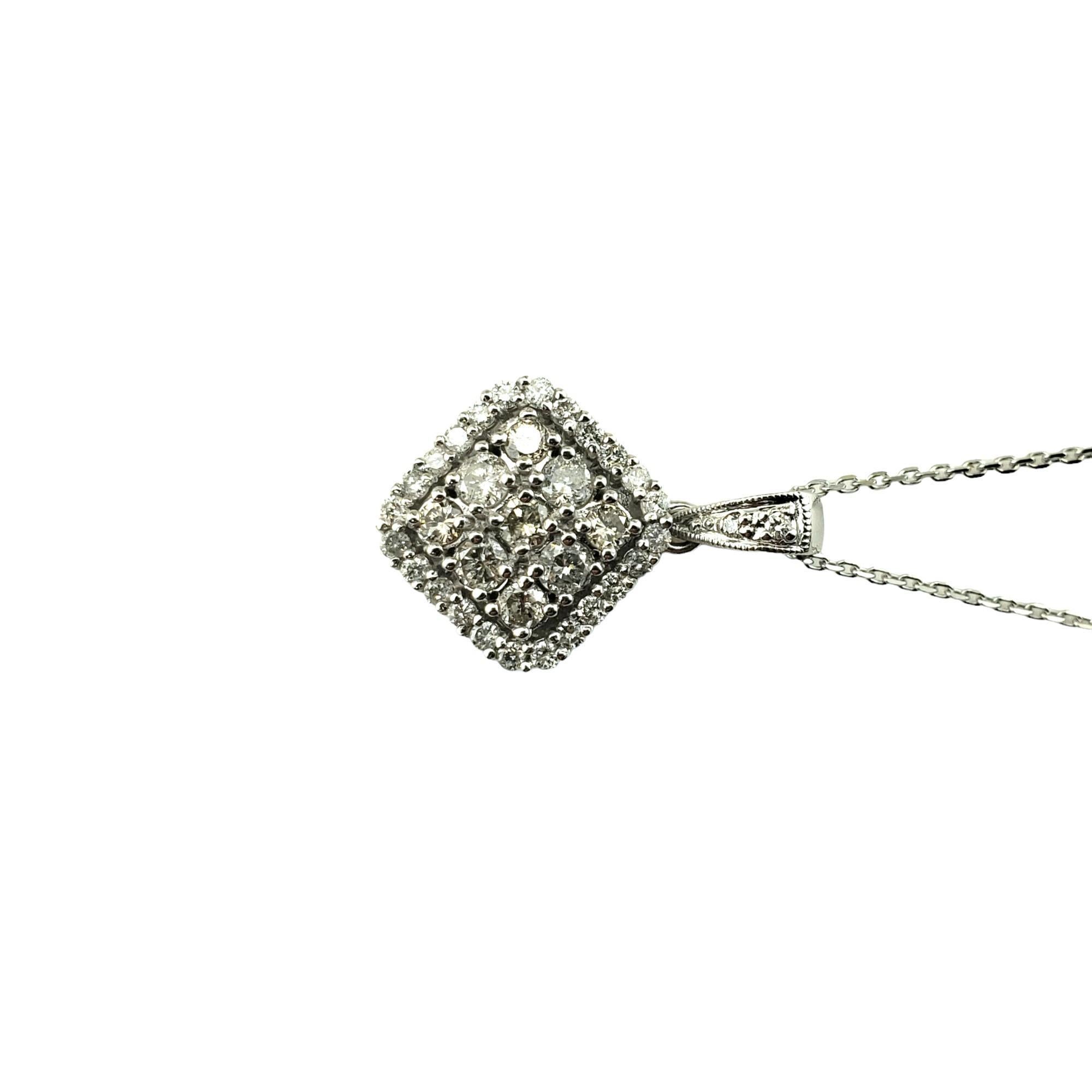 Vintage 14 Karat White Gold Diamond Pendant Necklace-

This sparkling pendant features 35 round brilliant cut diamonds set in classic 14K white gold.  Suspends from a classic cable necklace.

Approximate total diamond weight:  .50 ct.

Diamond