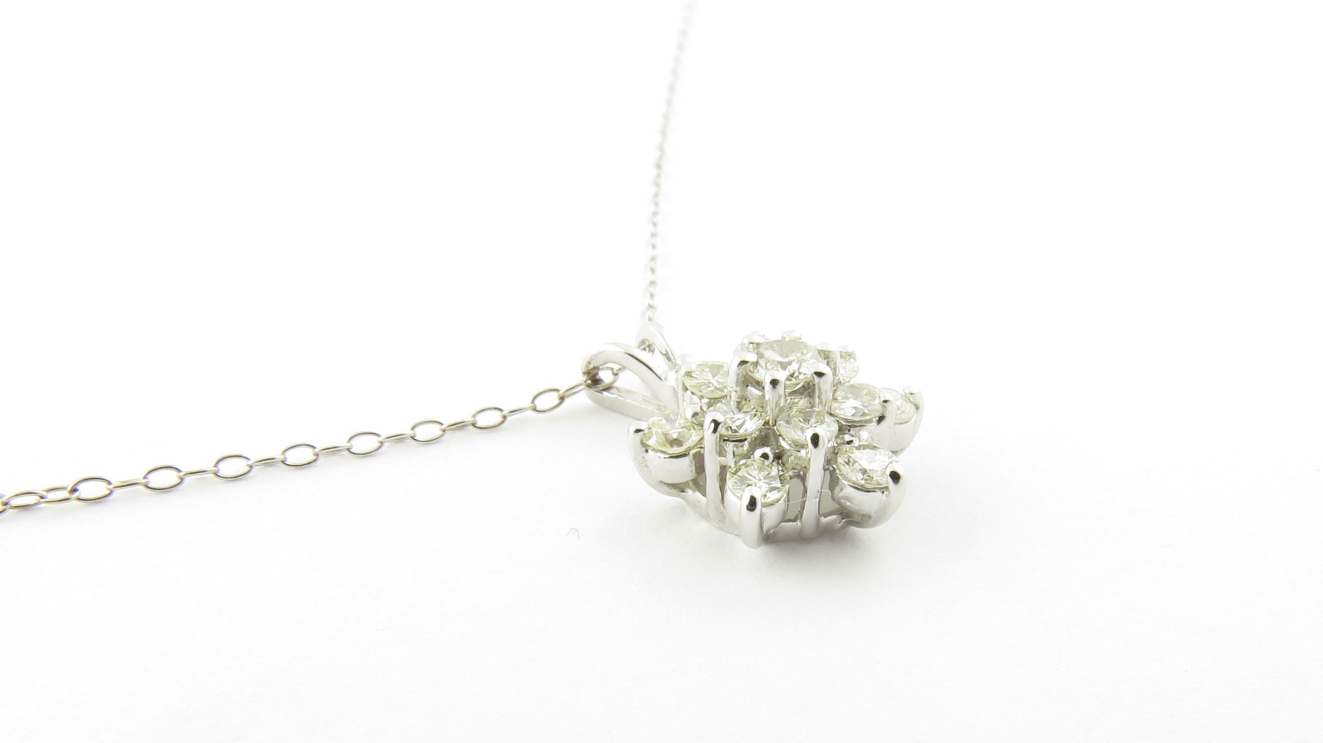 Vintage 14 Karat White Gold Diamond Pendant Necklace-

This sparkling pendant features 13 round brilliant cut diamonds (center: .08 ct., surrounding: .03 ct each) set in beautifully detailed 14K white gold. Suspended from a classic 14K white gold