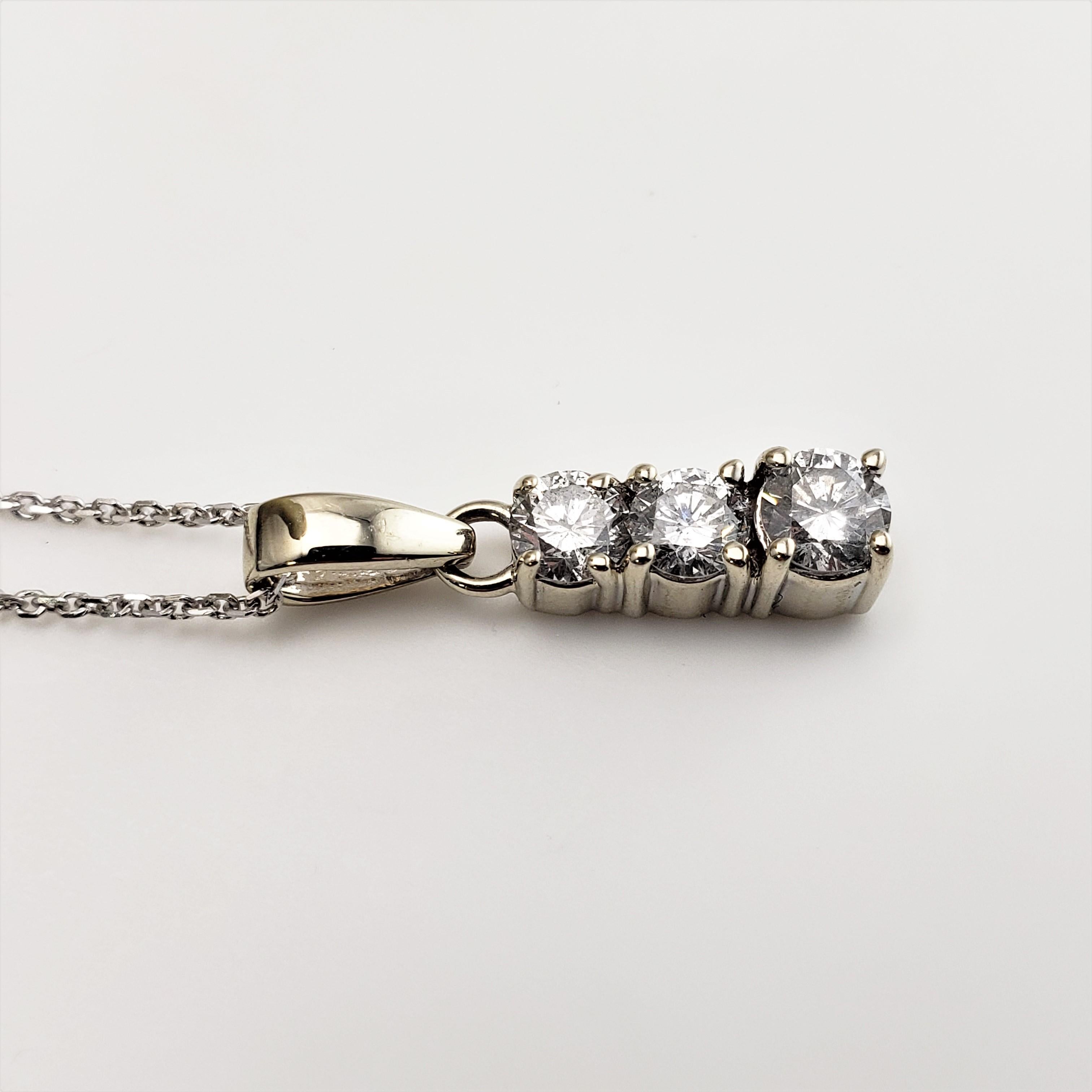 14 Karat White Gold Diamond Pendant Necklace-

This sparkling pendant features three round brilliant cut diamonds (.20 ct., .25 ct., .30 ct.) suspended from a classic cable necklace.

Approximate total diamond weight:  .75 ct.

Diamond color: 
