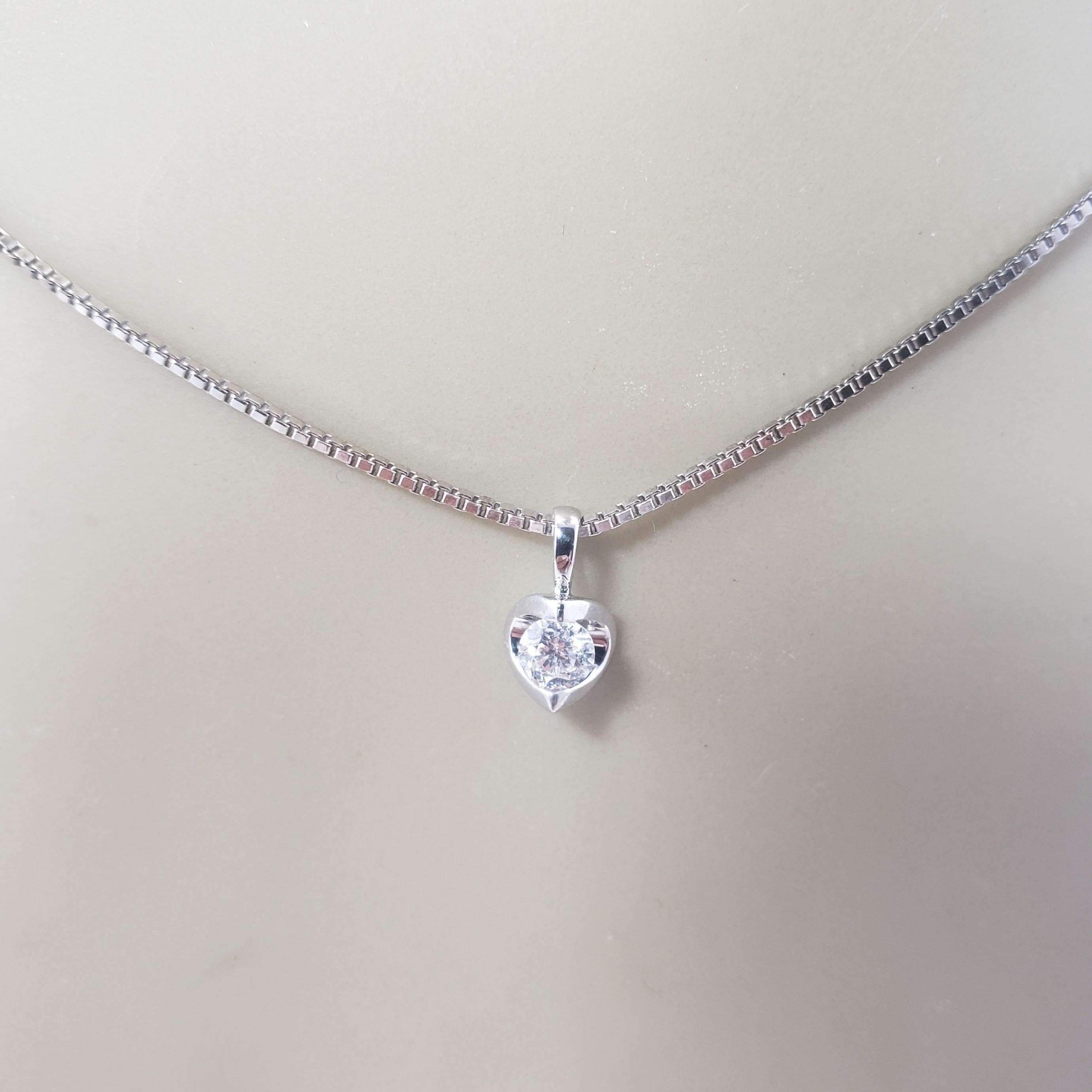 Vintage 14 Karat White Gold Diamond Pendant Necklace-

This lovely solitaire pendant features one round brilliant cut diamond set in classic 14K white gold. Suspends from a classic box chain.

Approximate total diamond weight: .18 ct.

Diamond