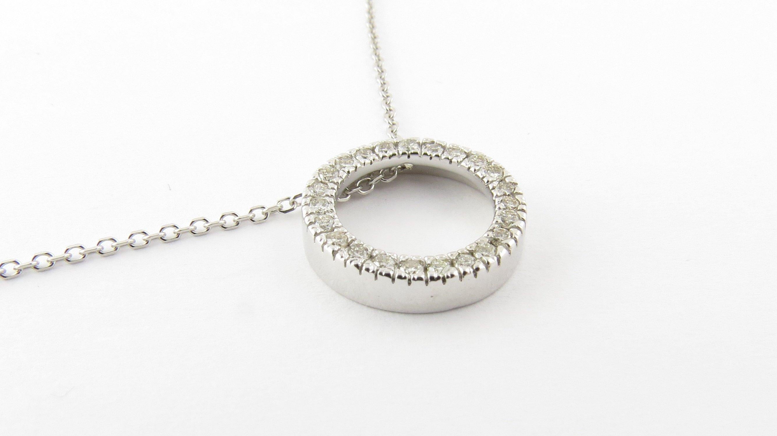 Vintage 14 Karat White Gold Diamond Pendant Necklace- 
This sparkling circle pendant features 24 round brilliant cut diamonds set in classic 14K white gold. 
Suspended from a classic cable necklace. 
Approximate total diamond weight: .24 ct.