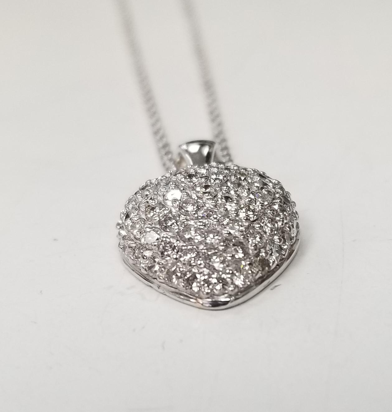 14k white gold diamond puffed heart, containing 65 round full cut diamonds of very fine quality weighing 1.61cts. on a 16 inch link chain.