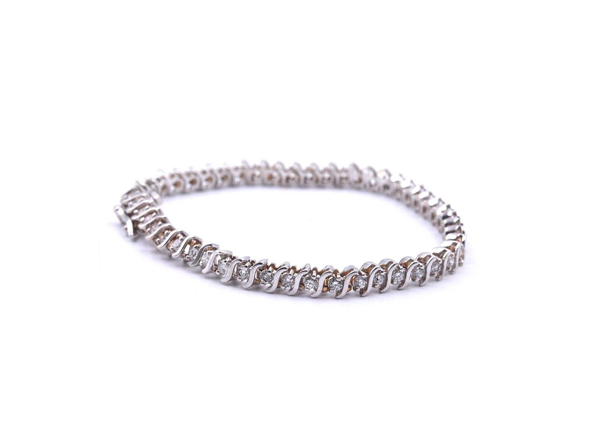 Designer: custom designed
Material: 14k white gold
Diamonds: 48 round brilliant cut = 1.50cttw
Color: J
Clarity: SI2
Dimensions: bracelet measures 7 ¼ inches mm wide and is 4.96mm wide
Weight: 15.00 grams
