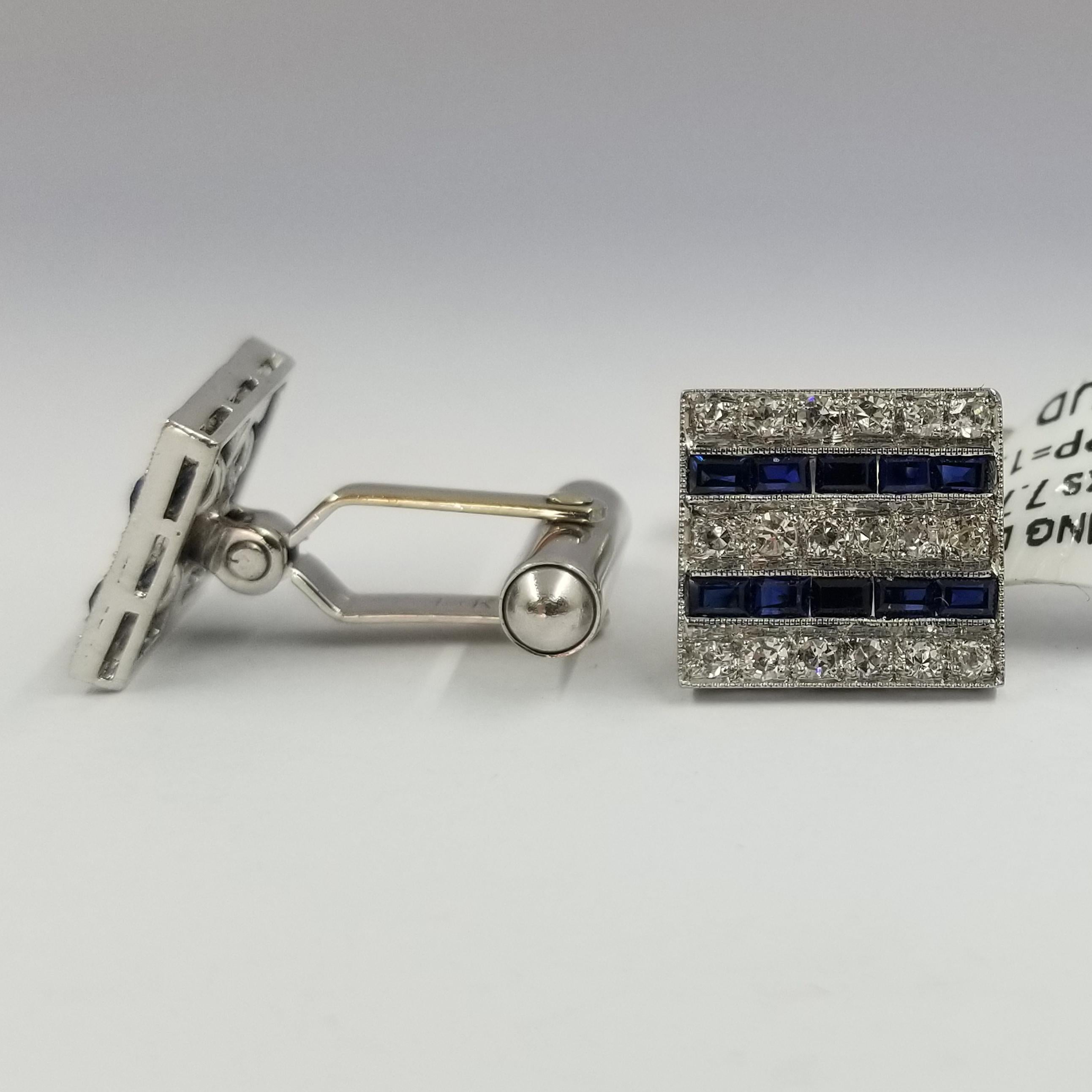 Set of 2 cufflinks crafted in 14 karat white gold (stamped). The hinged fronts feature 36 prong set single cut diamonds and 20 channel-set baguette cut sapphires. The diamond weight totals approximately 0.36 carat; the sapphire weight totals