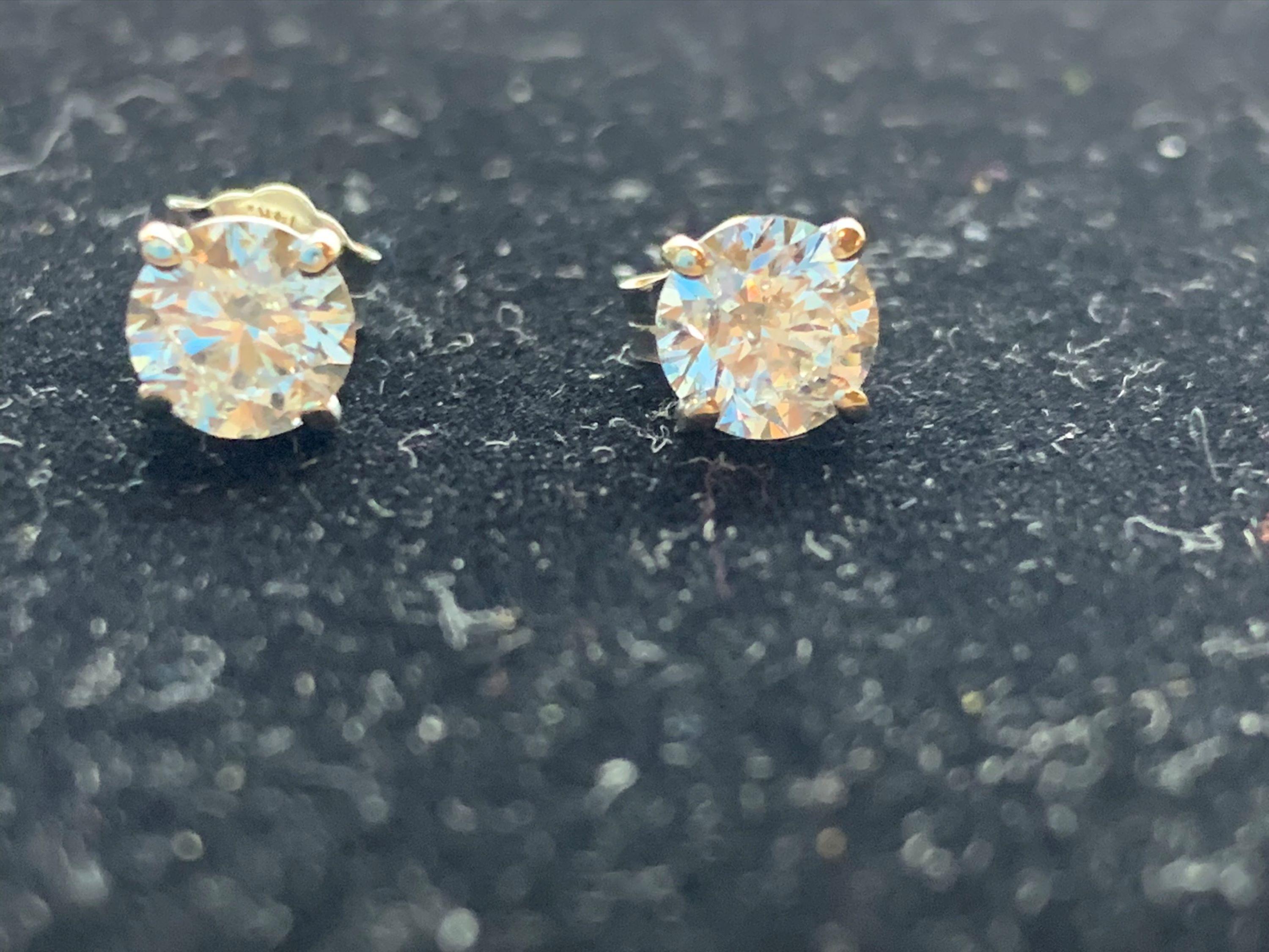 14k white gold studs, each with a diamond solitaire, tcw 1.00 carats. Screw backs. 