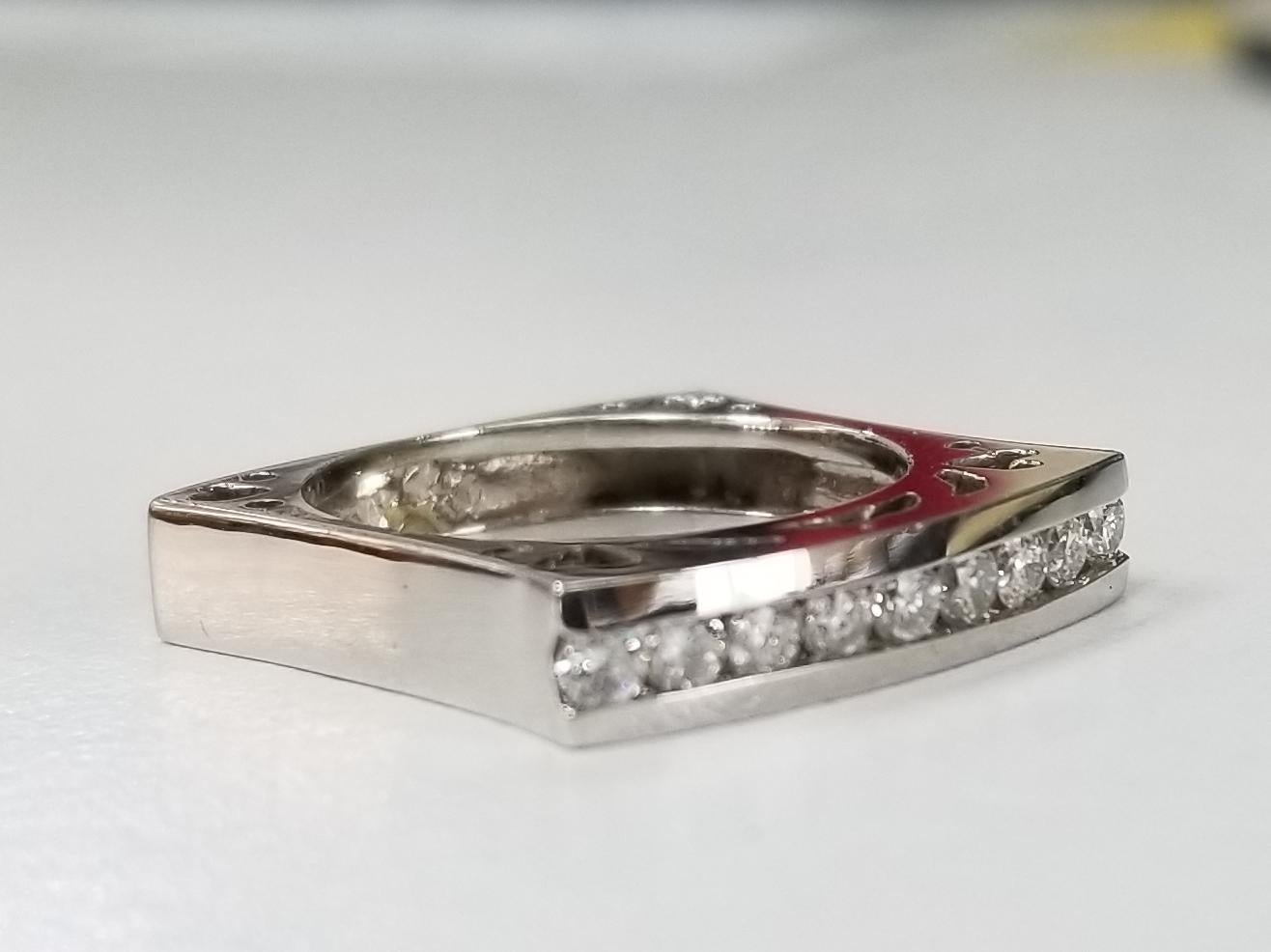 14 karat white gold diamond square ring, containing 9 round full cut diamonds of very fine quality weighing .45pts. with cut outs on the side.  This ring is a size 6 but we will size to fit for free.