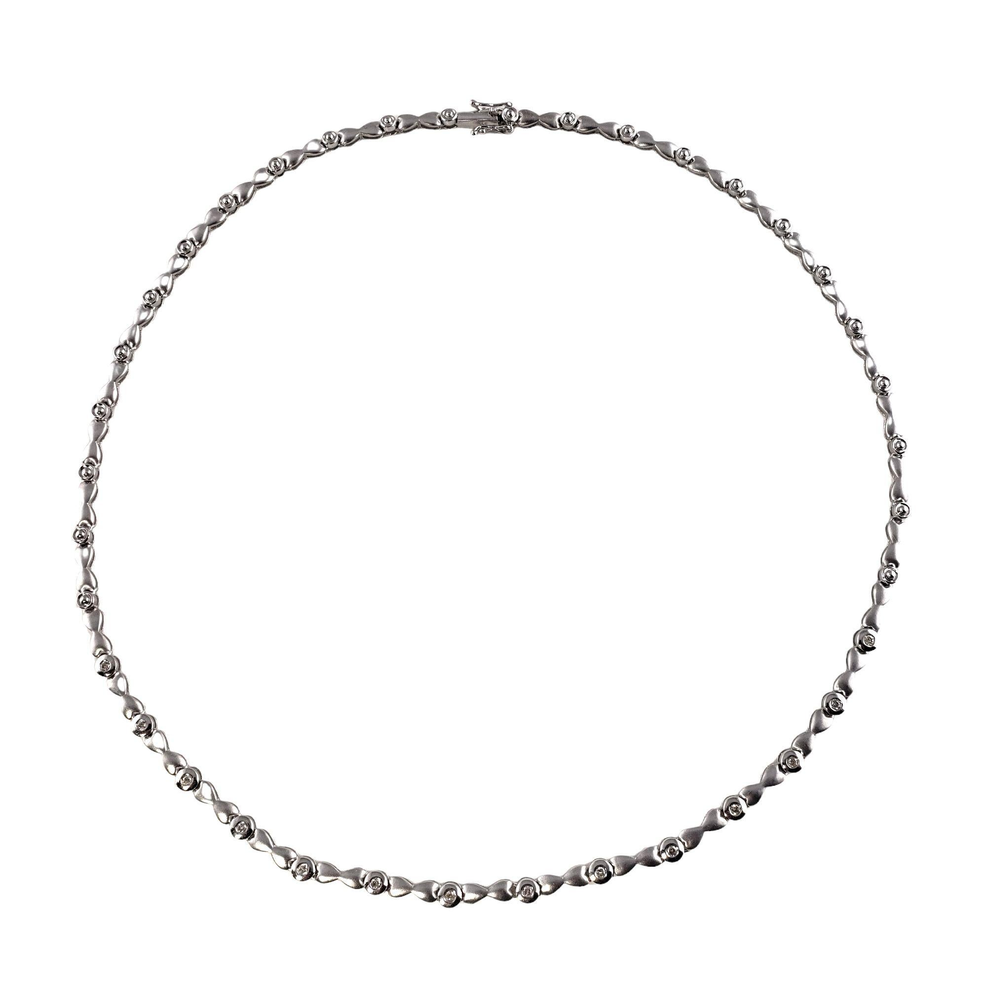 Vintage 14 Karat White Gold Diamond Station Necklace-

This sparkling station necklace features 14 round brilliant cut diamond set in beautifully detailed 14K white gold. Width: 4 mm.

Approximate total diamond weight: .28 ct.

Diamond color: