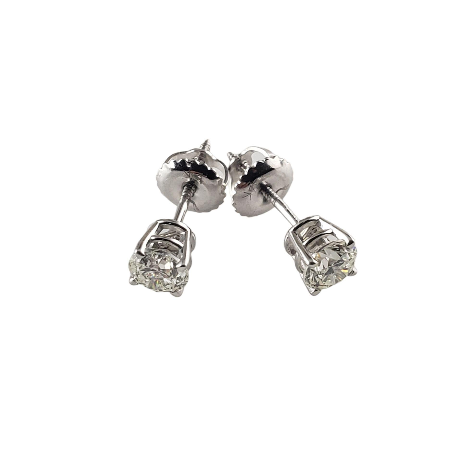 These sparkling earrings each feature one round brilliant cut diamond set in classic 14K white gold. Screw back closures.

Approximate diamond weight: .60 ct.

Diamond color: I

Diamond clarity: I1

Size: 5 mm

Weight:  0.7 gr./ 0.4 dwt.

Stamped: 