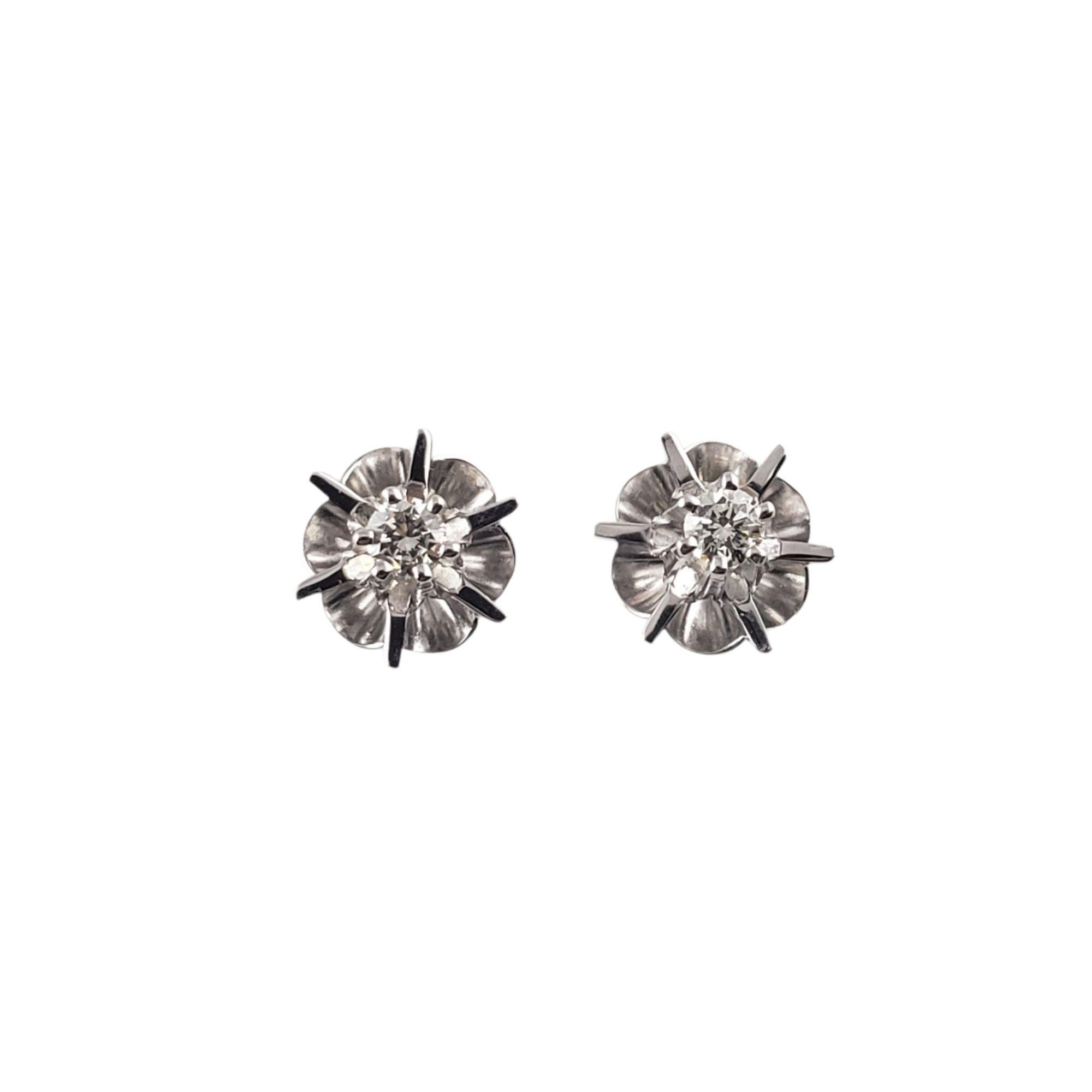 Vintage 14 Karat White Gold and Diamond Stud Earrings-

These sparkling earrings each feature one round brilliant cut diamond set in classic 14K white gold.  Push back closures.

Approximate diamond weight: .12 ct.

Diamond color: G

Diamond