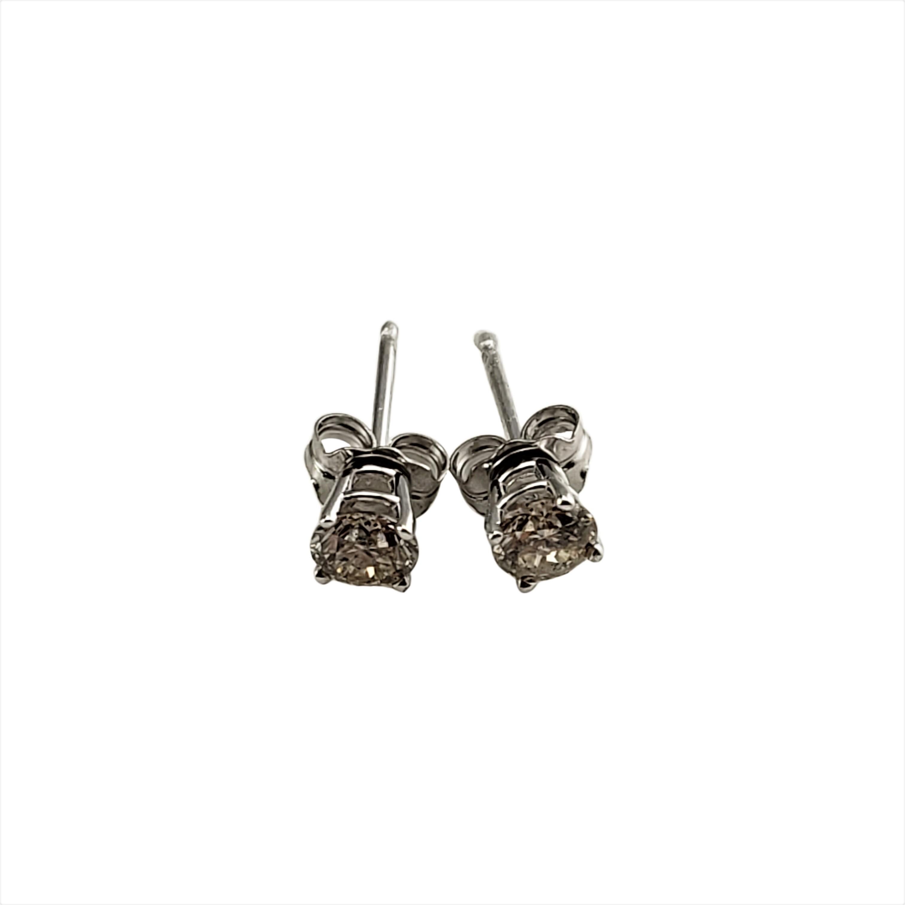 14 Karat White Gold Diamond Stud Earrings .50 tcw.-

These sparkling stud earrings each feature one round brilliant cut diamond set in classic 14K white gold.  Push back closures.

Approximate total diamond weight:  .50 ct.

Diamond color: 