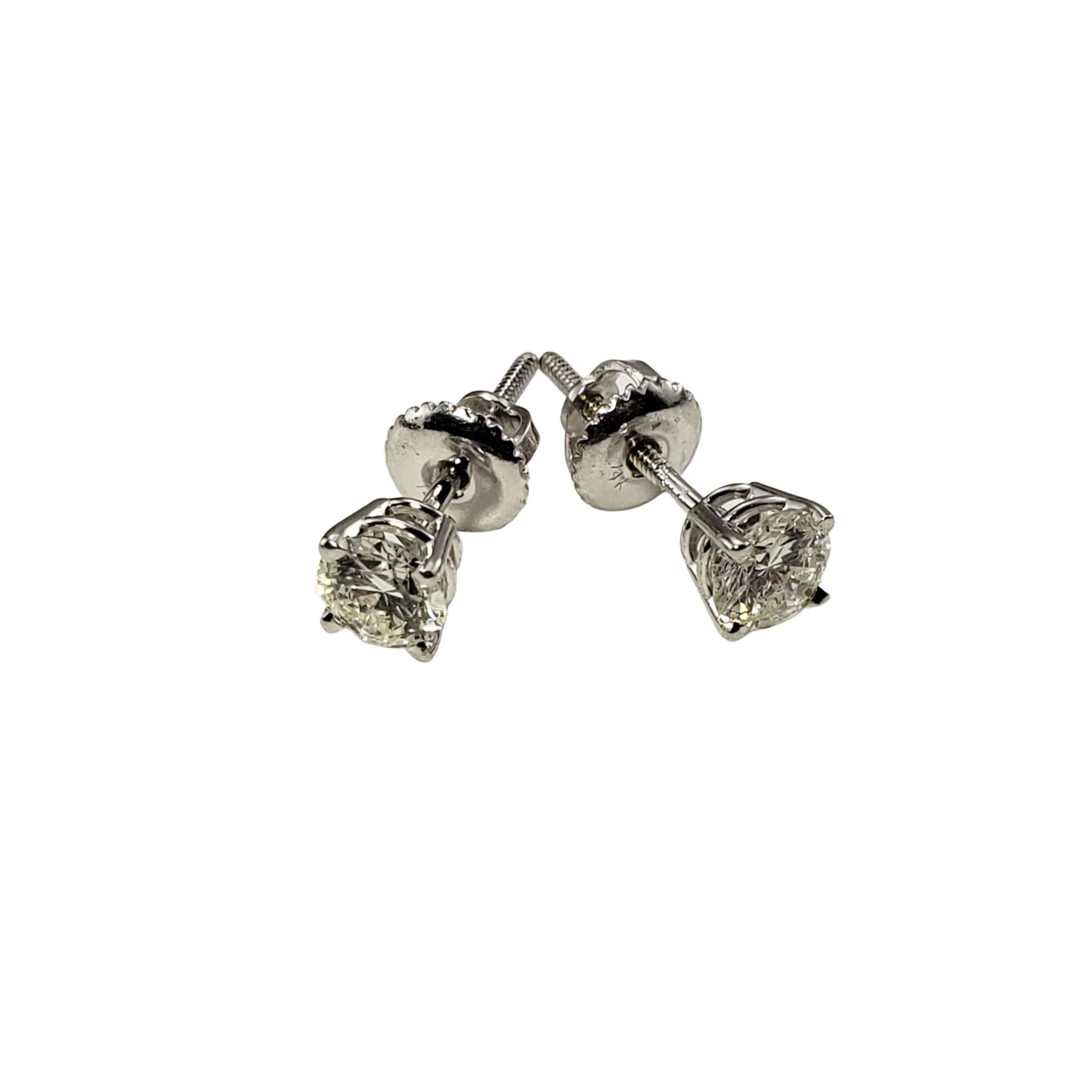 14 Karat White Gold Diamond Stud Earrings .74 TCW.-

These sparkling stud earrings each feature one round brilliant cut diamond set in classic 14K white gold.  Screw back closures.

Approximate total diamond weight:   .74 ct.

Diamond color: 