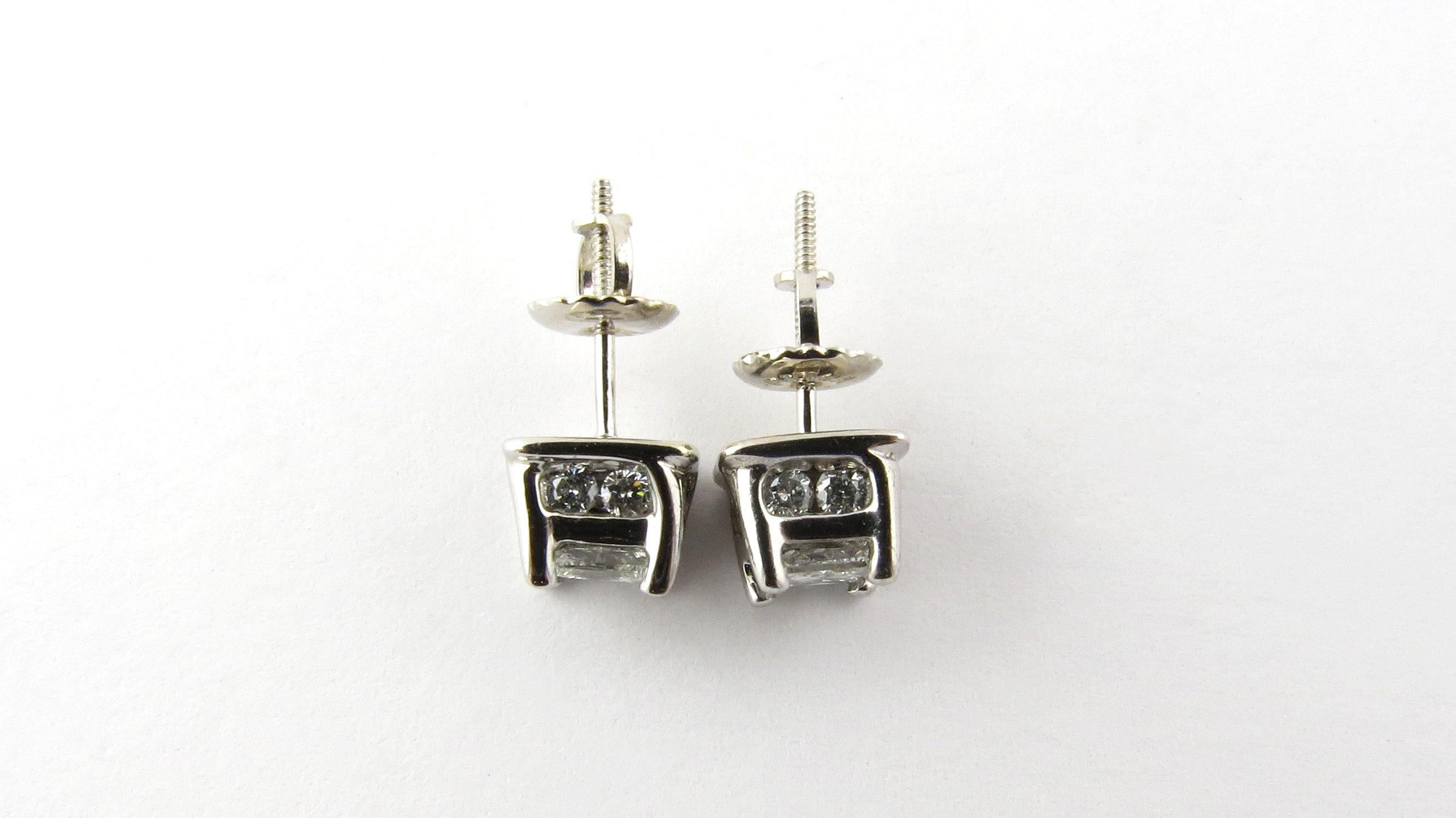 Vintage 14 Karat White Gold Diamond Stud Earrings .82 ct. twt.- 
These stunning stud earrings each feature one princess cut diamond (.25 ct.) accented with eight round brilliant cut diamonds and set in classic 14K white gold. Screw back closures.