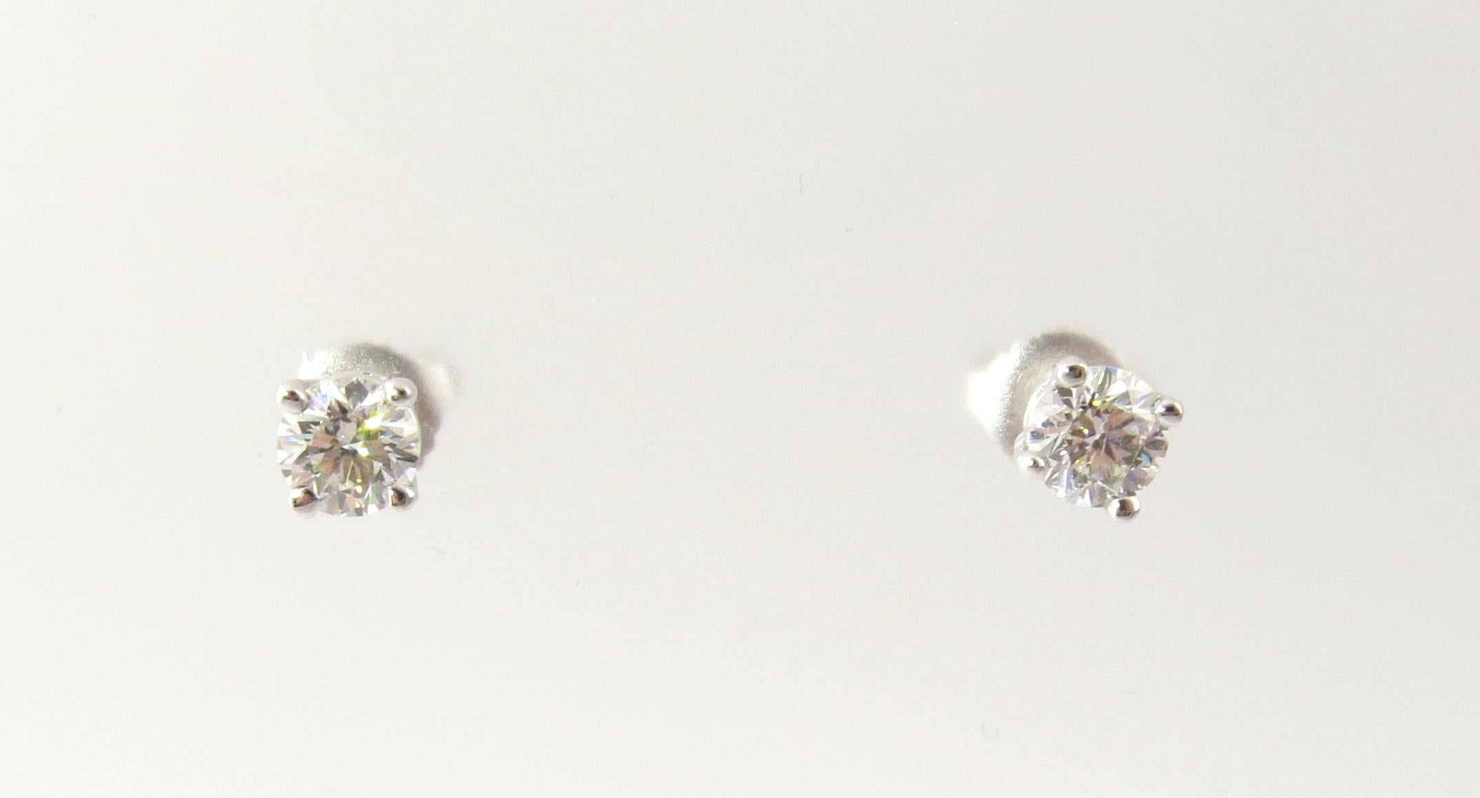 Vintage 14 Karat White Gold Diamond Stud Earrings .86 ct. twt.

These sparkling stud earrings each feature one round brilliant cut diamond set in classic 14K white gold. Push back closures.

Approximate total diamond weight: .86 ct.

Diamond color:
