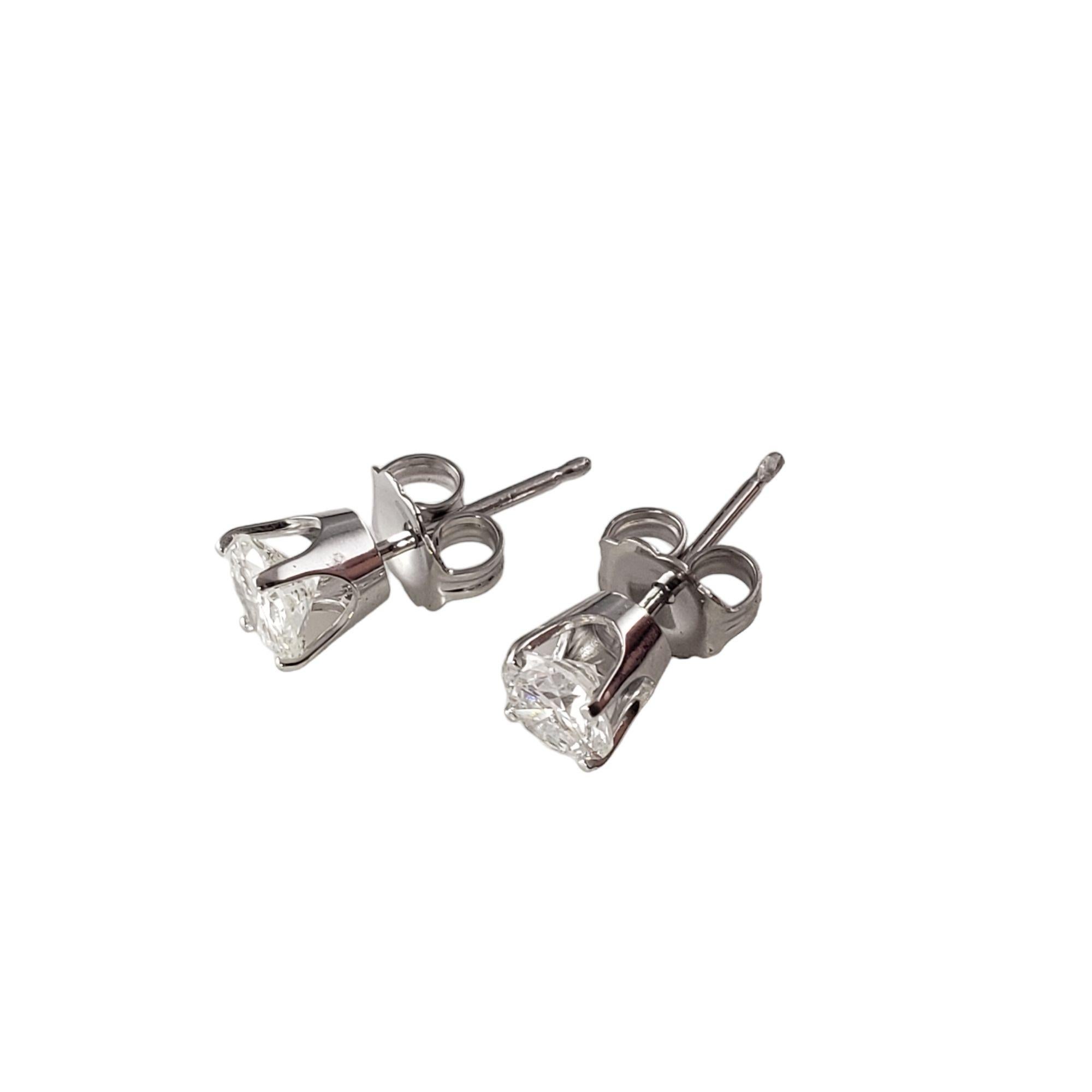 Vintage 14 Karat White Gold Diamond Stud Earrings .90 TCW. JAGi Certified-

These sparkling stud earrings each feature one round brilliant cut diamond set in classic 14K white gold. Push back closures.

Total diamond weight: .90 ct.

Diamond color: