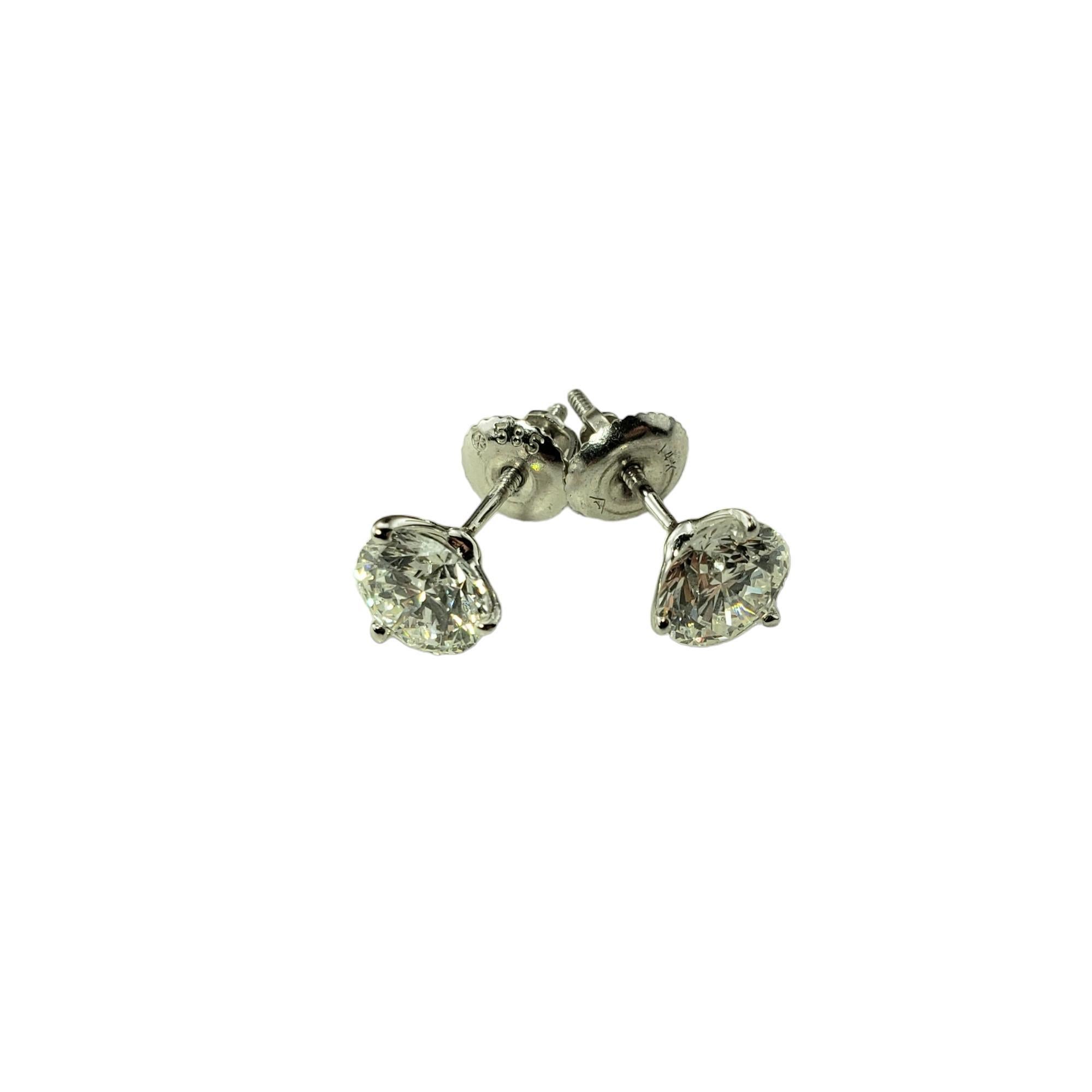 Vintage 14 Karat White Gold Diamond Stud Earrings JAGi Certified-

These sparkling stud earrings each feature one round brilliant cut diamond set in classic 14K white gold.  Screw back closures. 

Total diamond weight:  1.76 ct.

Diamond clarity: 