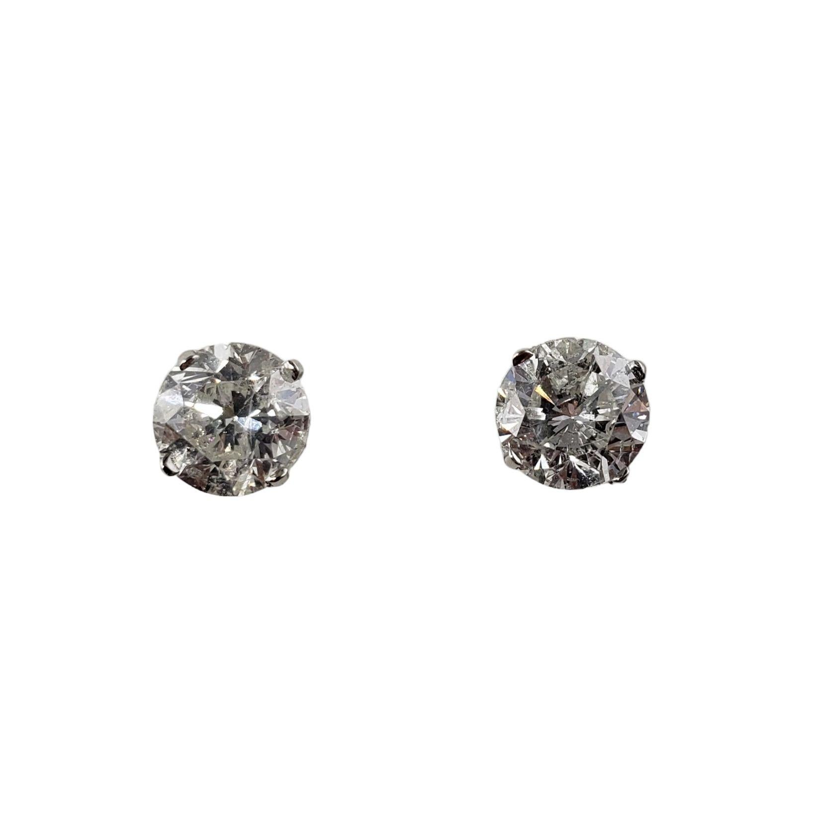 Vintage 14 Karat White Gold Diamond Stud Earrings JAGi Certified-

These sparkling earrings each feature one laser drilled & fracture filled round brilliant cut diamond set in classic 14K white gold. Screw back closures.

Total diamond weight: 1.76