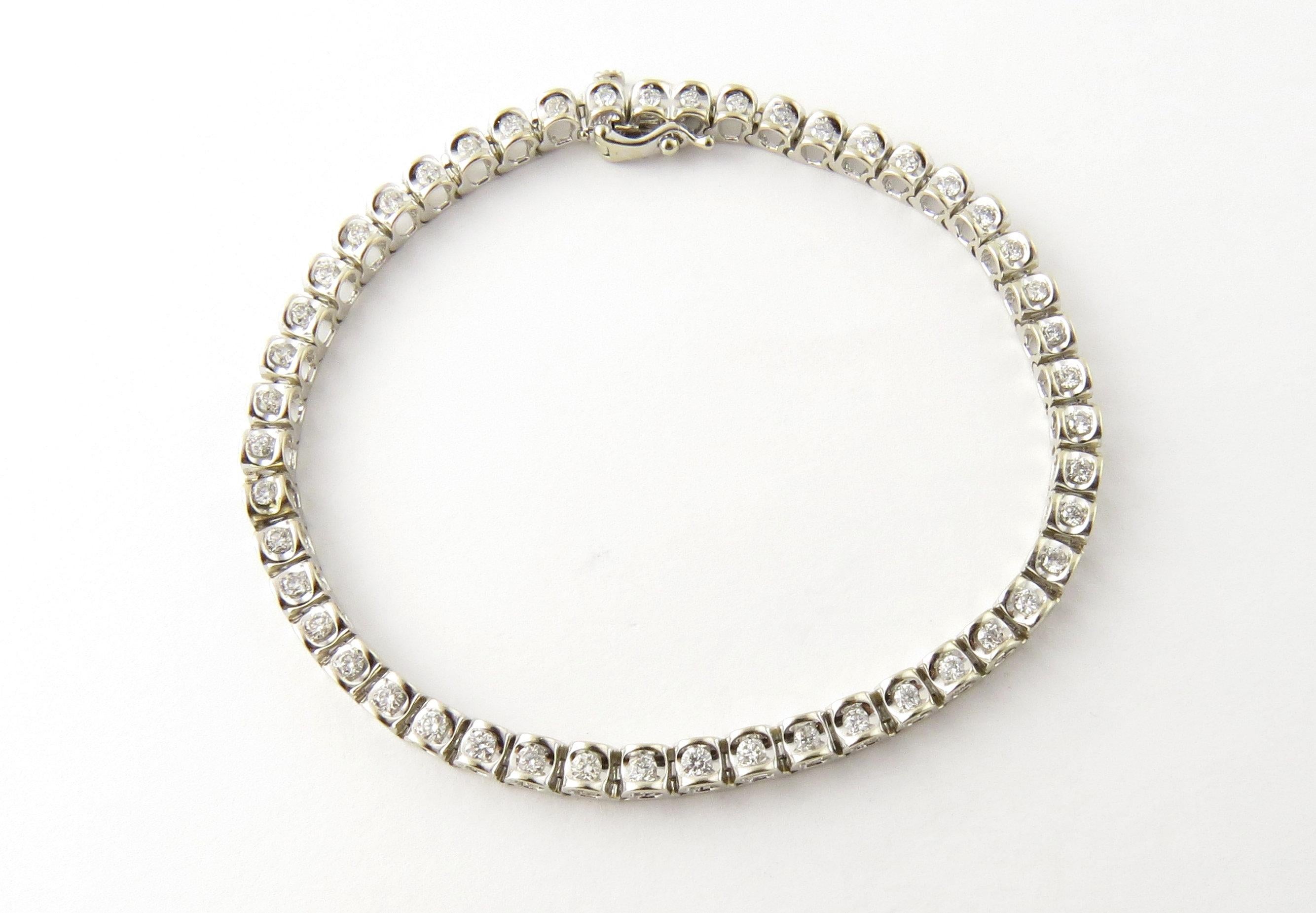 Vintage 14 Karat White Gold Diamond Tennis Bracelet 1.5 TCW- 
This sparkling tennis bracelet features 48 round brilliant cut diamonds set in classic 14K white gold. 
Total carat weight: 1.5 ct. 
Diamond color: H-I 
Diamond clarity: SI-I1 
Size: 8