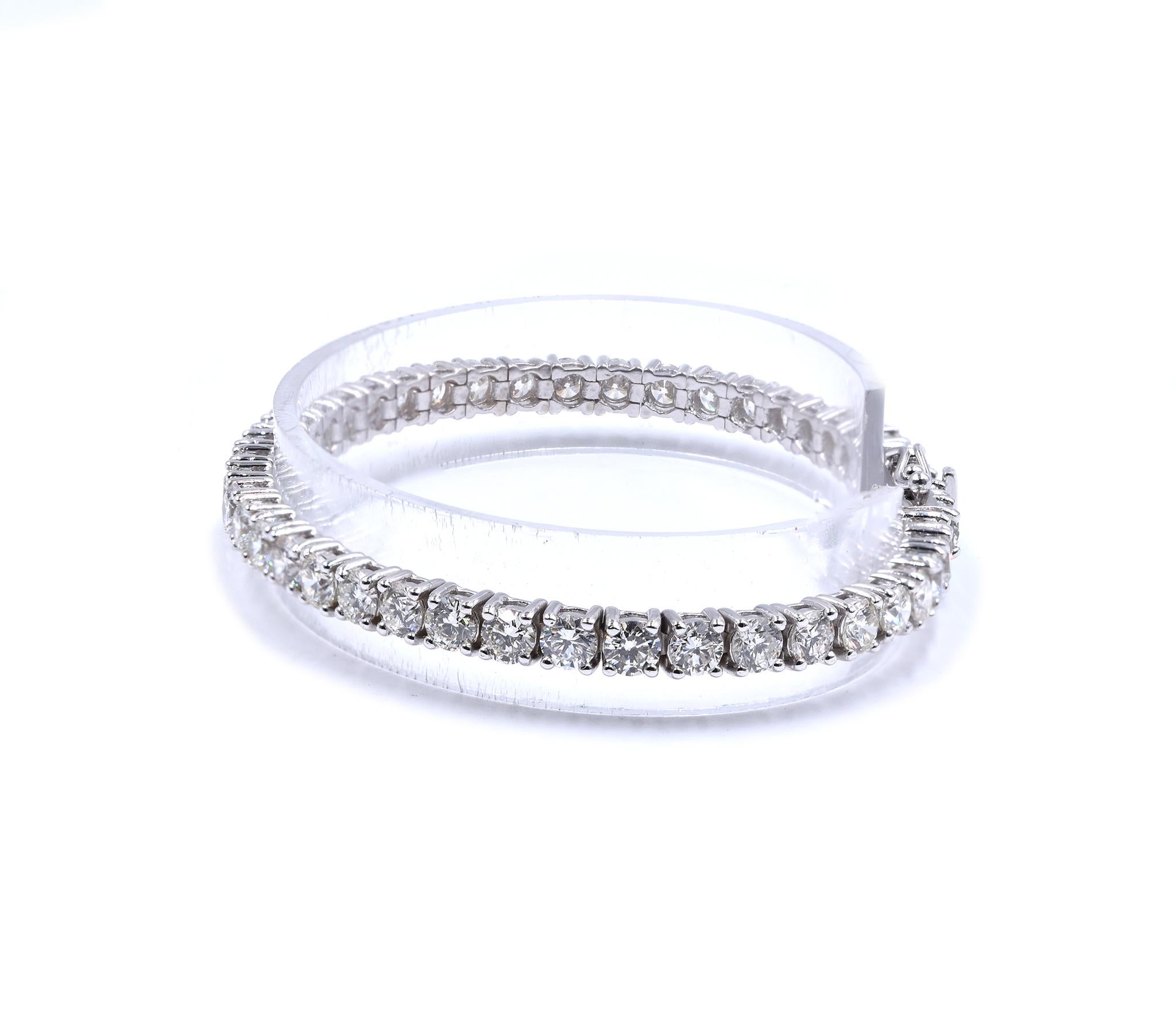 Designer: custom
Material: 14K white gold
Diamonds: 44 round brilliant cut = 10.79cttw
Color: I
Clarity: SI1
Dimensions: bracelet will fit up to a 7-inch wrist
Weight: 15.92 grams
