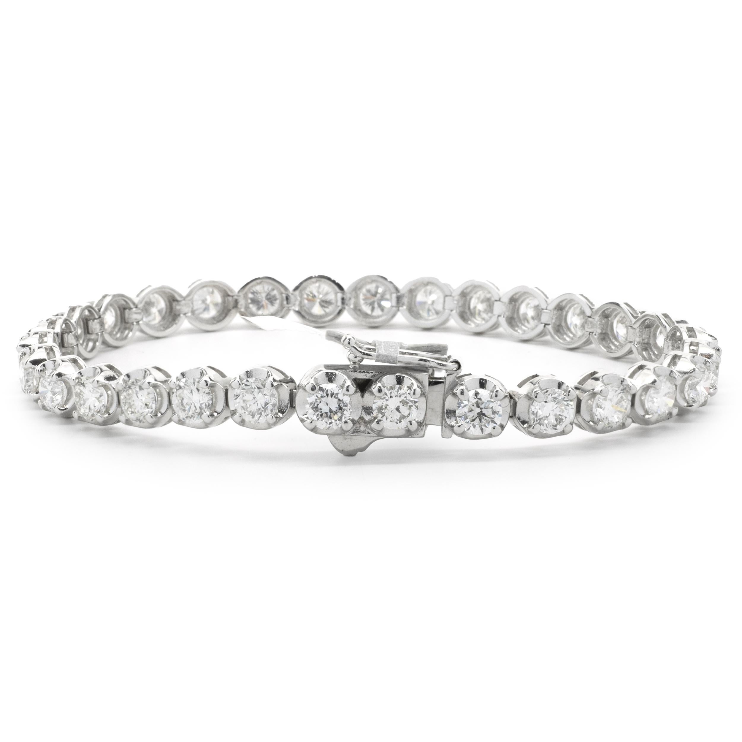 Designer: custom
Material: 14K white gold
Diamond: 30 round brilliant cut = 9.92cttw
Color: F/G
Clarity: VS2
Dimensions: bracelet will fit up to a 7-inch wrist
Weight: 15.99 grams
