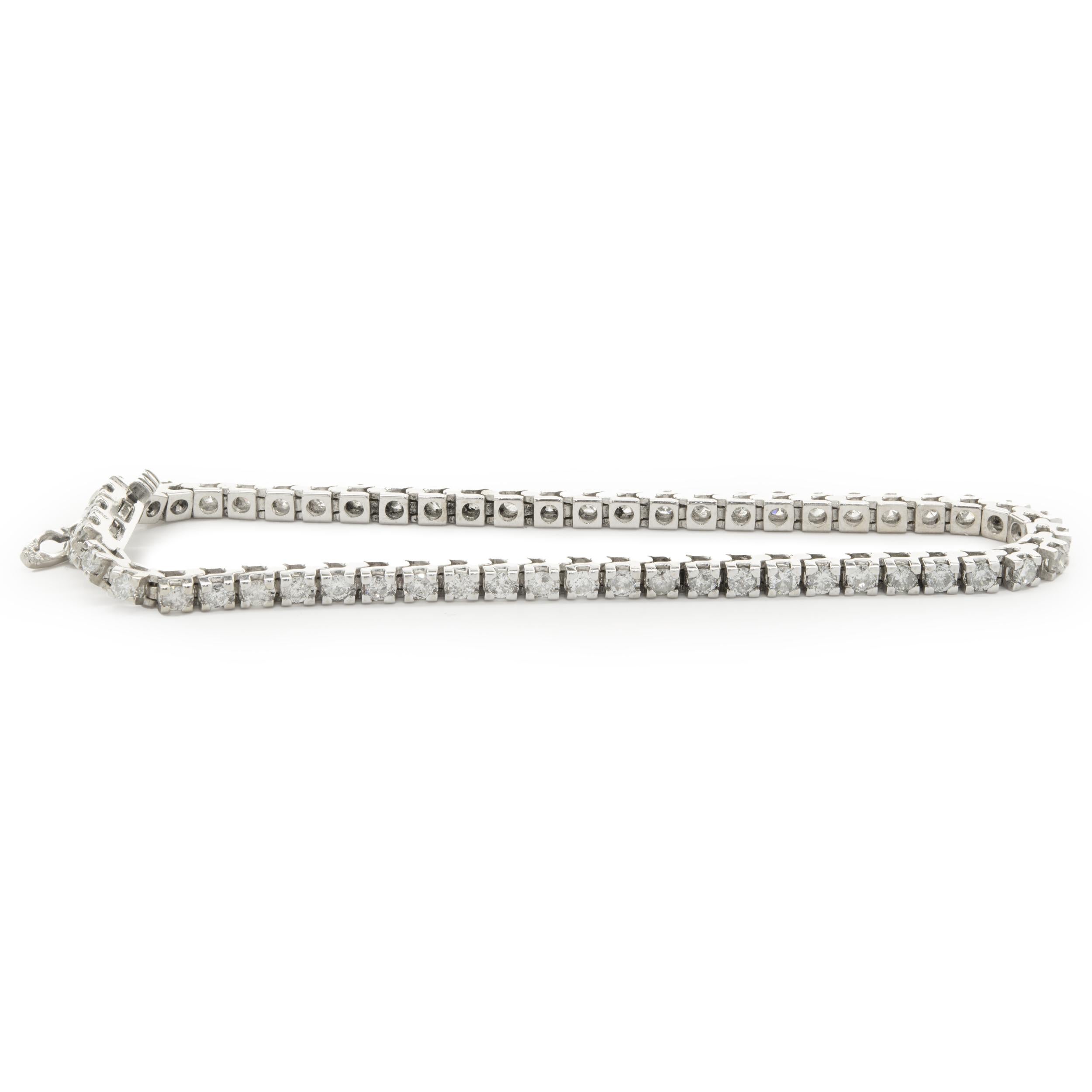Designer: custom
Material: 14K white gold
Diamond: 55 round brilliant= 2.75cttw
Color: H / I
Clarity: I1
Dimensions: bracelet will fit up to a 7.25inch wrist
Weight: 12.90 grams
