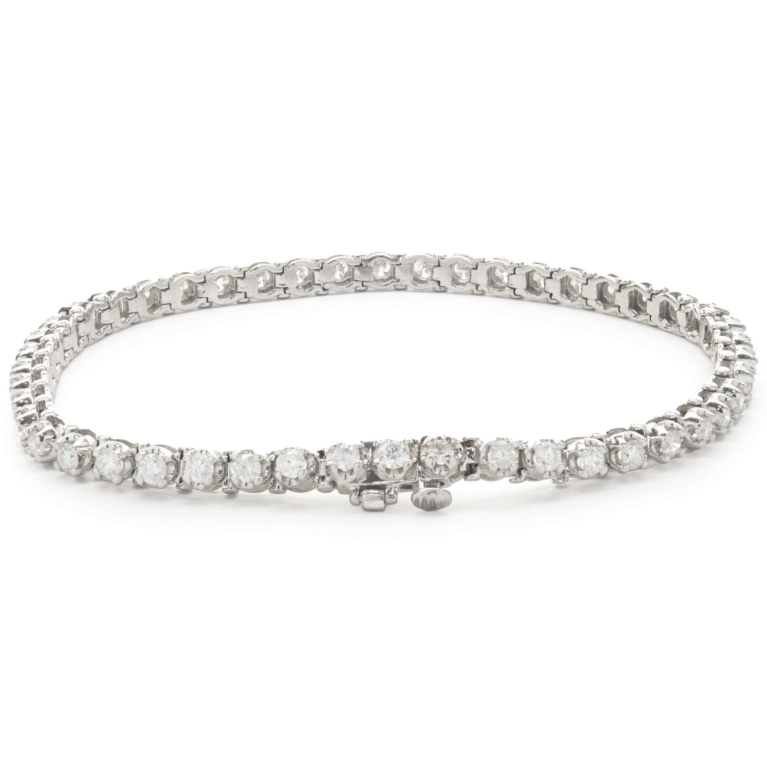 Designer: custom design
Material: 14K white gold
Diamonds: 47 round brilliant cut = 2.35cttw
Color: H
Clarity: I1-2
Dimensions: bracelet will fit up to a 7-inch wrist
Weight: 11.03 grams