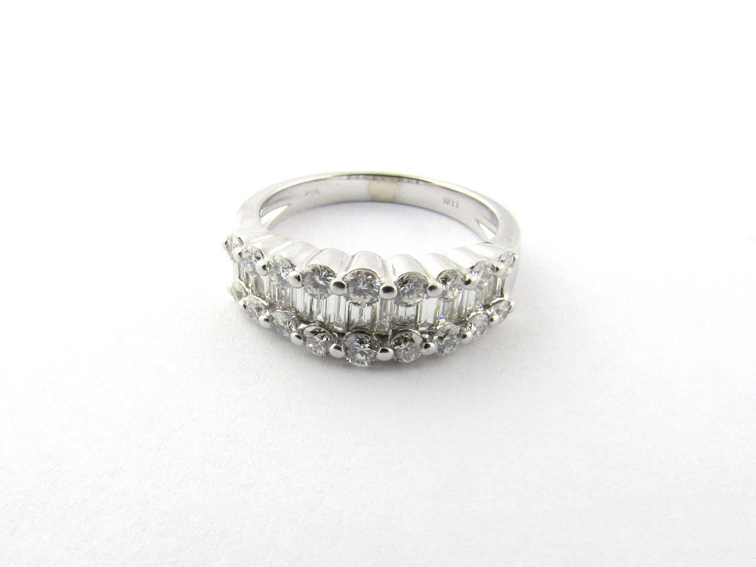 Vintage 14 Karat White Gold Diamond Wedding Band Size 6.25

This stunning ring features one row of 17 baguette diamonds weighing approximately .05 ct. each. and two rows of nine round cut diamonds: 

2 x .06 ct. 

4 x .05 ct. 

4 x .04 ct. 

4 x .03