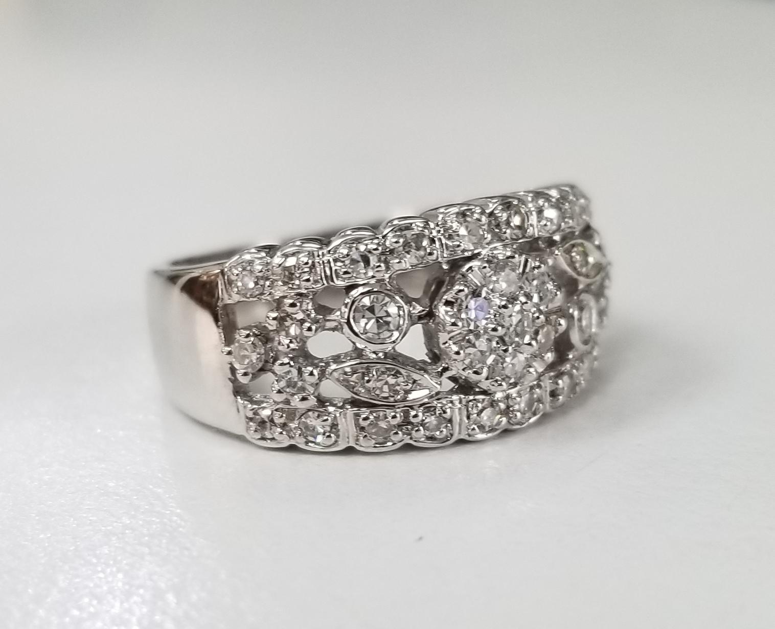 14 karat white gold diamond wedding ring, containing 37 round single cut diamonds of very fine quality weighing .65pts.  This ring is a size 7 but we will size to fit for free.