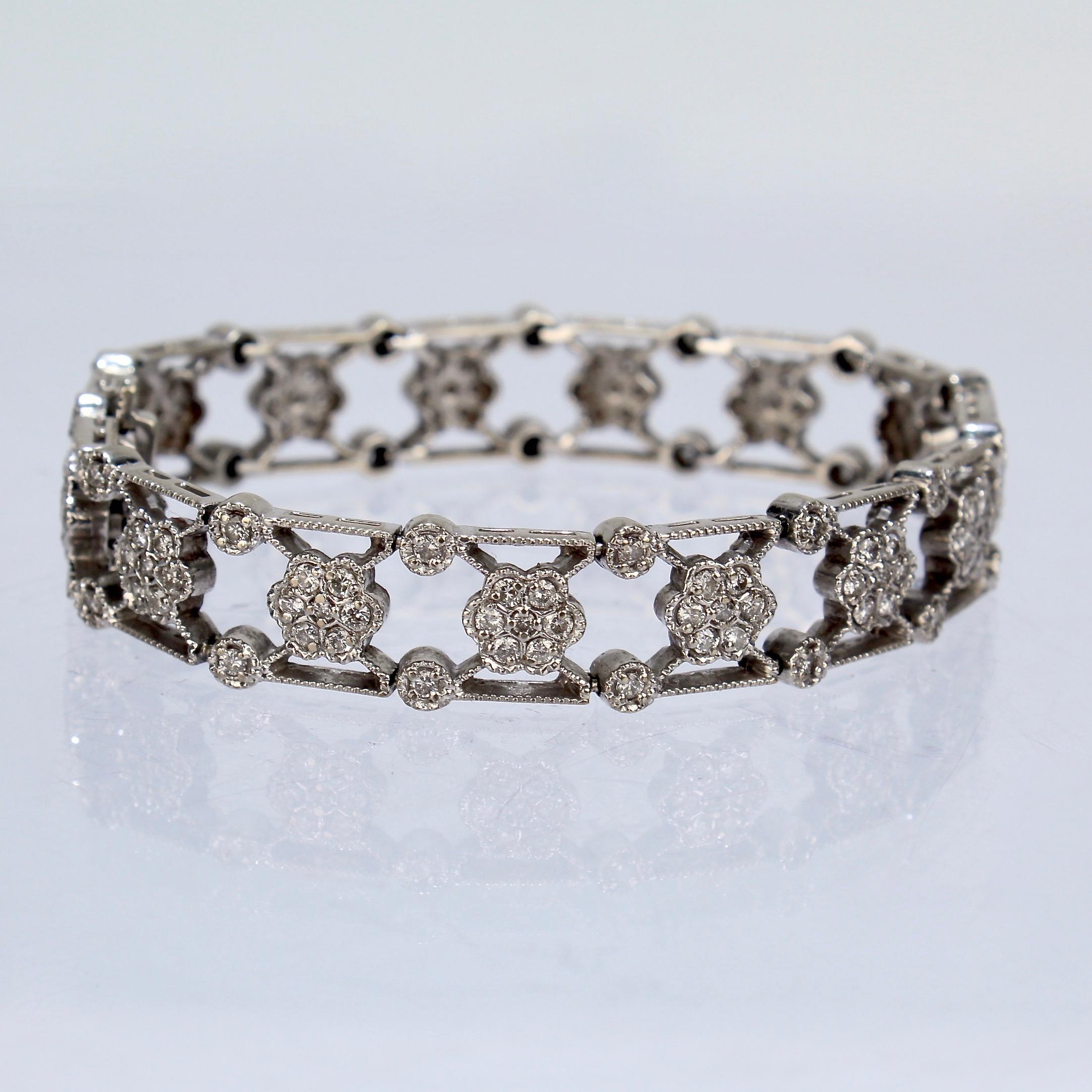 A fine 14K white gold and diamond bracelet.

In an intricate X-link pattern set with florets of diamonds centered on the X and punctuated by bezel set diamonds on its edges.

An eye-catching bracelet!

Marked 14k for gold fineness. 

Length: ca. 172